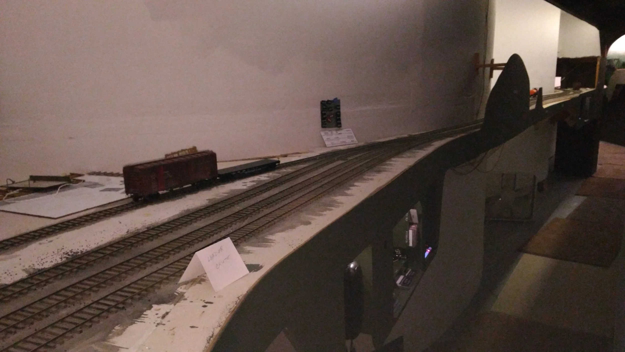A look at Brooks. Darwin is in the adjacent distance. Operator access to the Kayford aisle is a nod-under directly behind me. The work station at Brooks includes a phone to communicate with the town of Kayford and a magnet board to keep track of where trains have been given track warrant to be. The Brooks operator acts as the Kayford Dispatcher. Design also put the A&O dispatcher's Linnwood phone nearby so the two honchos can conspire together. 
