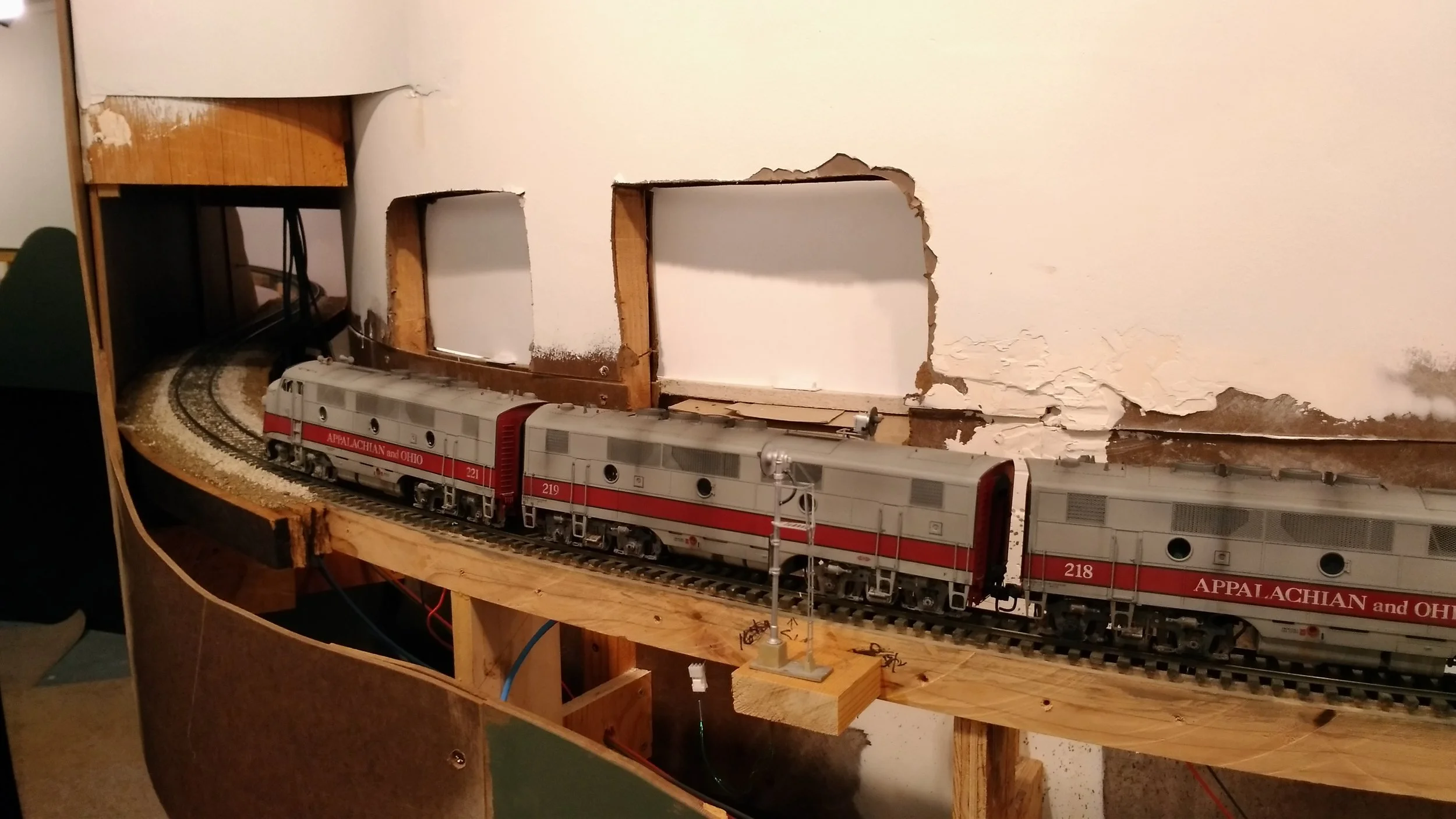 Typical of mountain railroading, the mainline now dives into County Line Tunnel and a gentle reverse curve. Once the tunnel liner is installed, the fascia will get its final spackle and paint, the last on the layout!