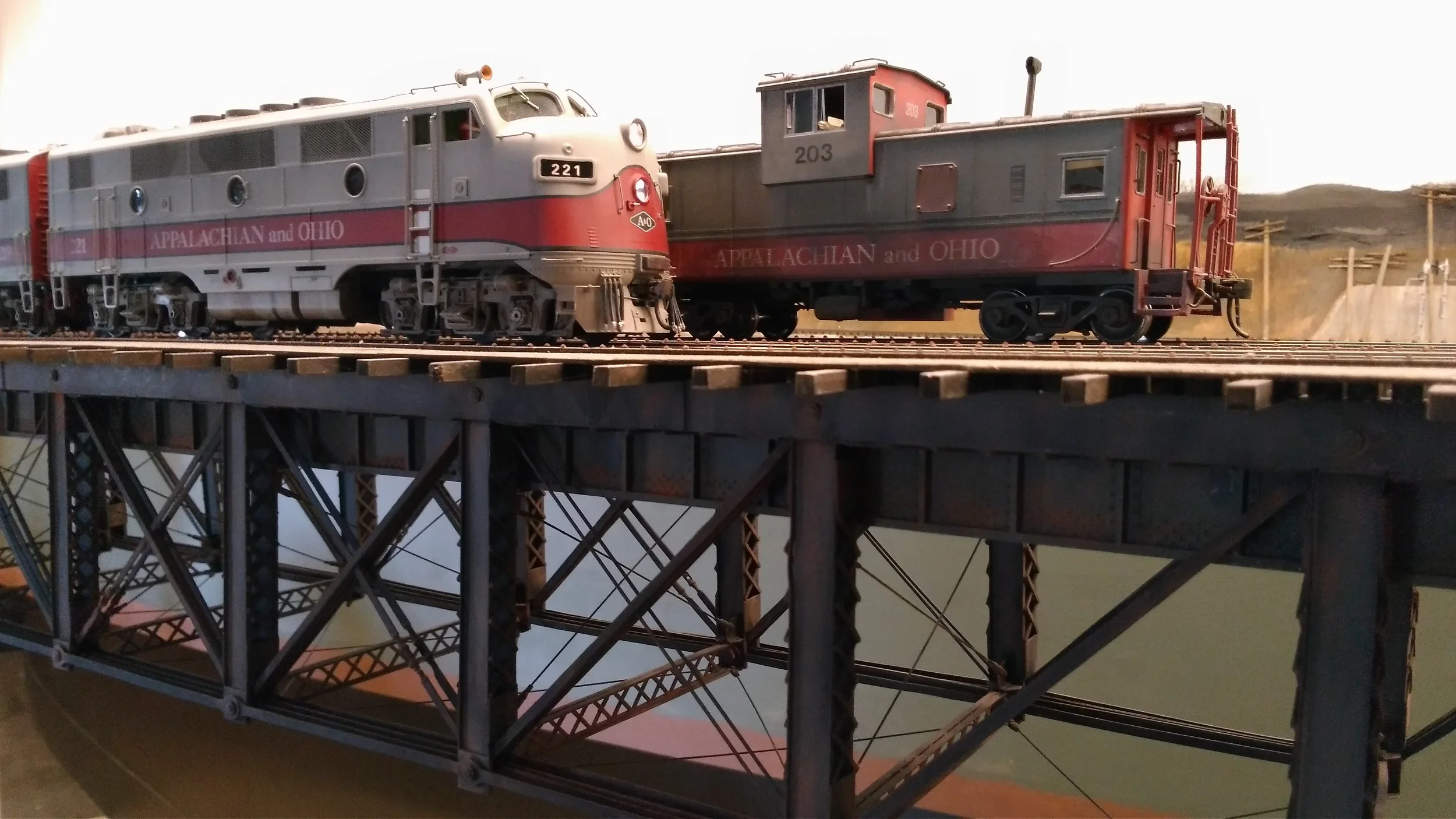 The dispatcher is holding a train at Jay as we cross the bridge, not an uncommon sight. This gives us a chance to pause and appreciate Vince Griesemer's beautiful scratch built deck truss. (And yes, we have a couple later photos, putting our train on the North Main.)