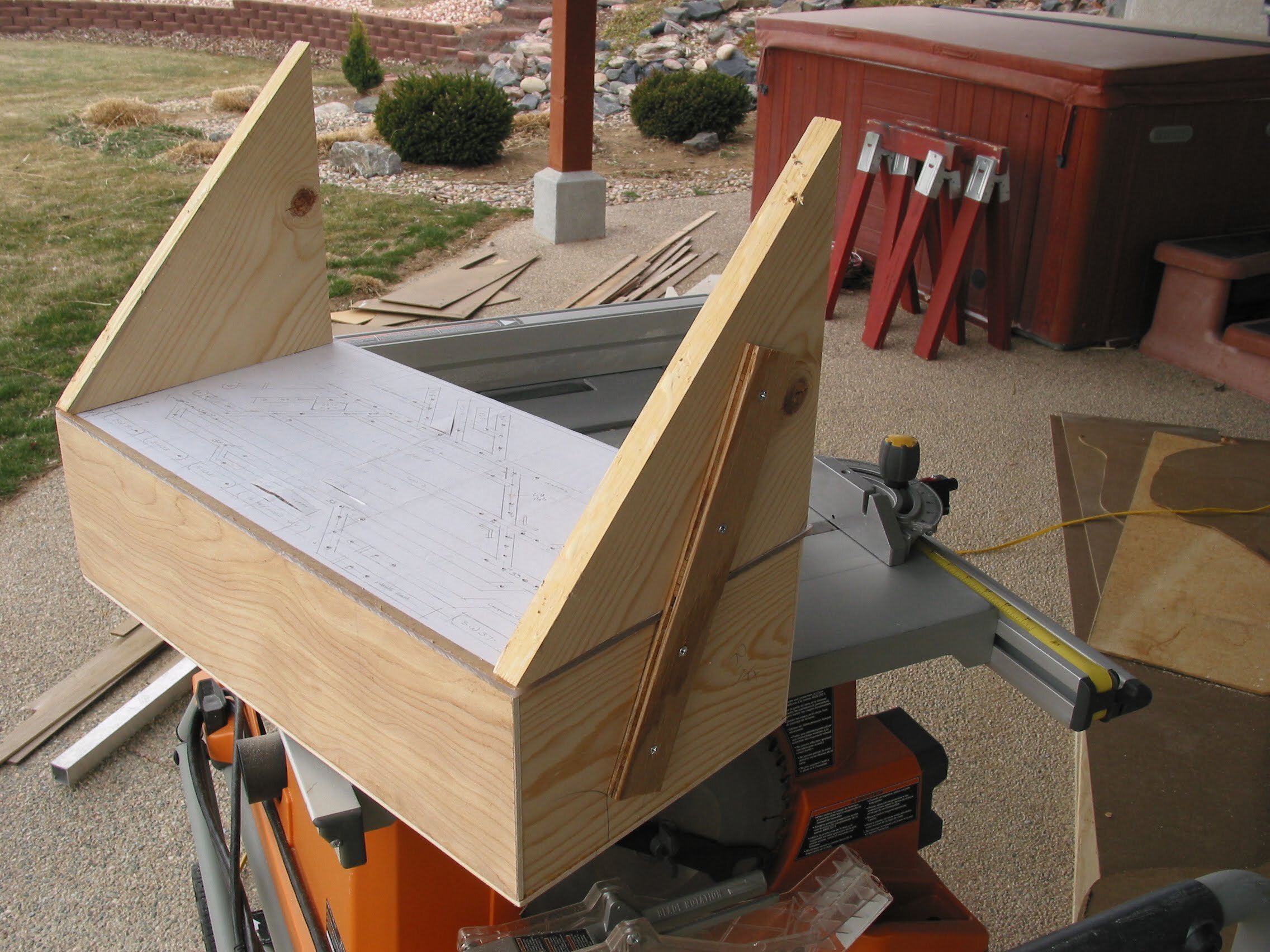  Building triangular mounting brackets for the panels. Depending upon aisle width, layout fascia height and thus viewing angle, the brackets varied greatly and all were one-of-a-kind. This photo shows the cut panel plex attached to reflector box with
