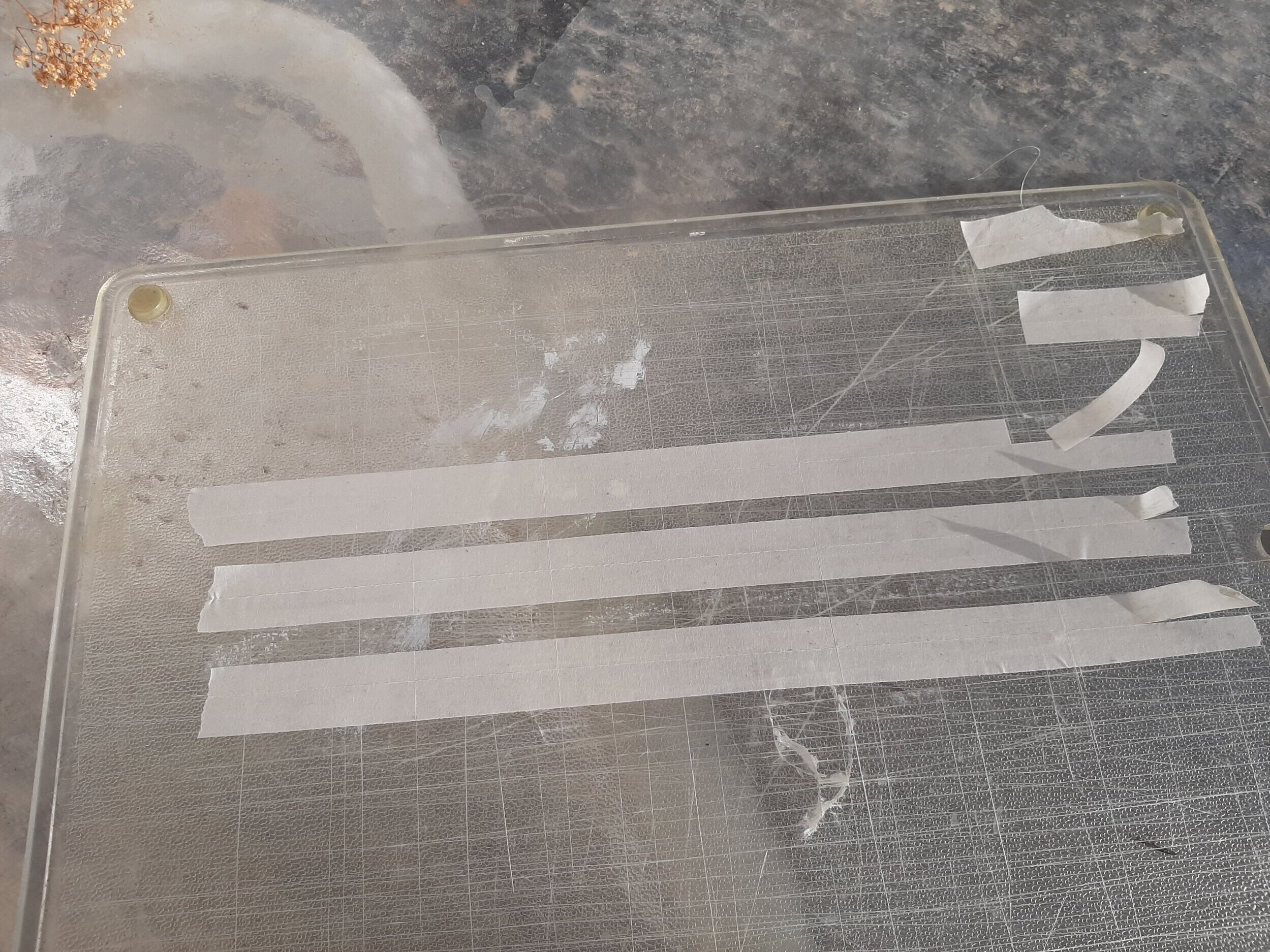  Masking tape is cut into smaller width strips with a straight edge and then crosscut to make smaller “tape wraps.” 