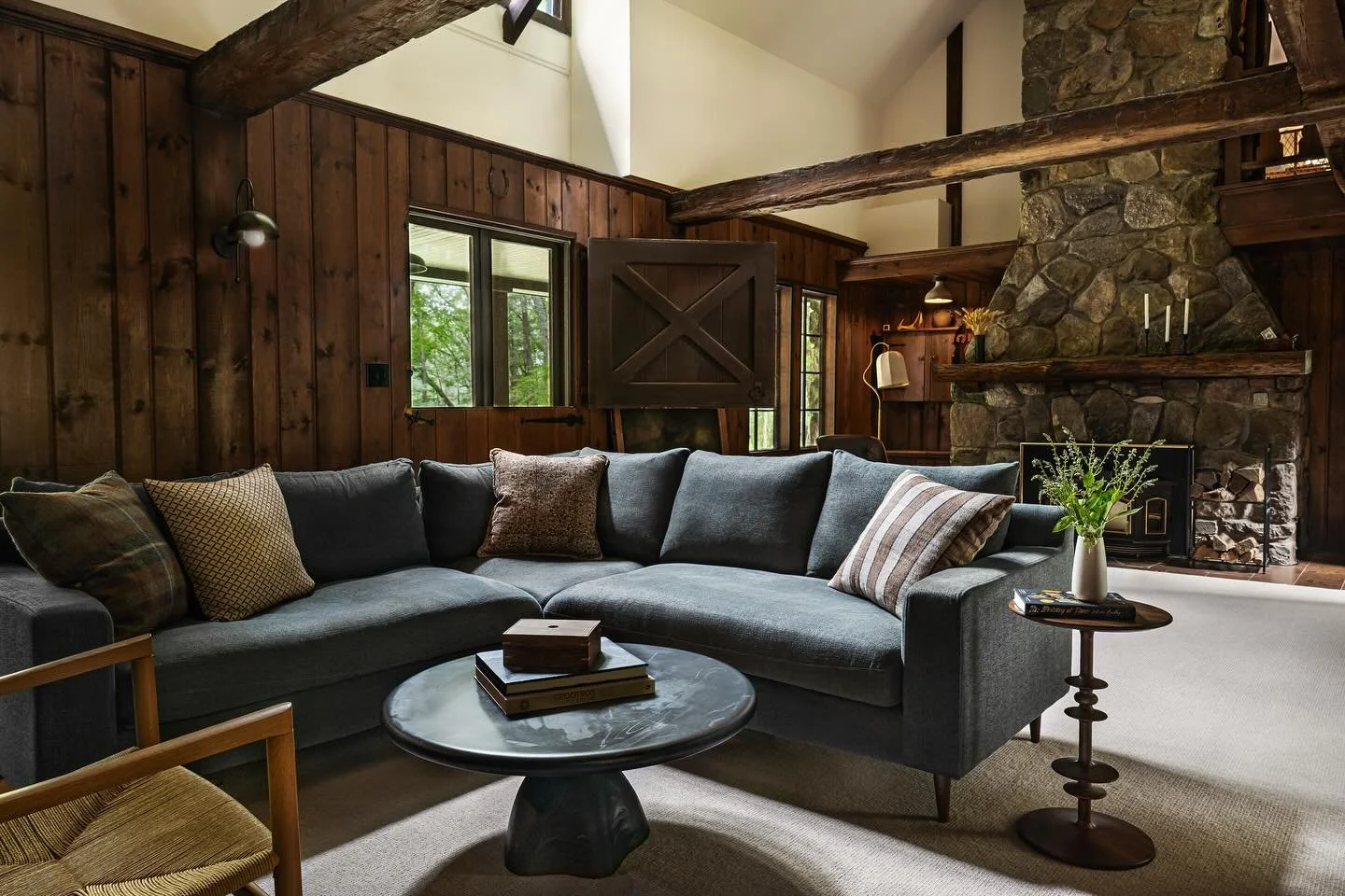 The cozy great room at Laroe road. Original wood paneling, a Dutch door, and a new warm white wall that opens to the new addition upstairs, bringing volume and verticality to the space. 

Interior Design: @cattaneostudios 
Photography: @jamieshieldsp