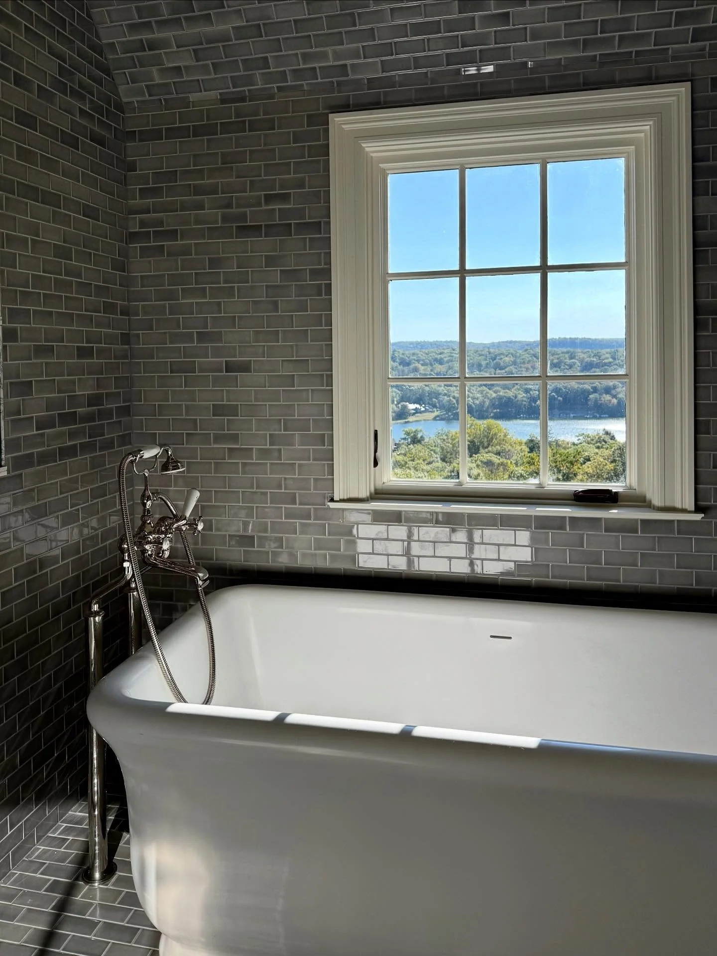 Nearing the finish line at a beautiful project here in Tuxedo Park. Taking the tile up onto the ceiling was so fun (for me.. not for the installers)! What a tub, what a view. 

Interior design : @cattaneostudios 
Tile work : @itileinc