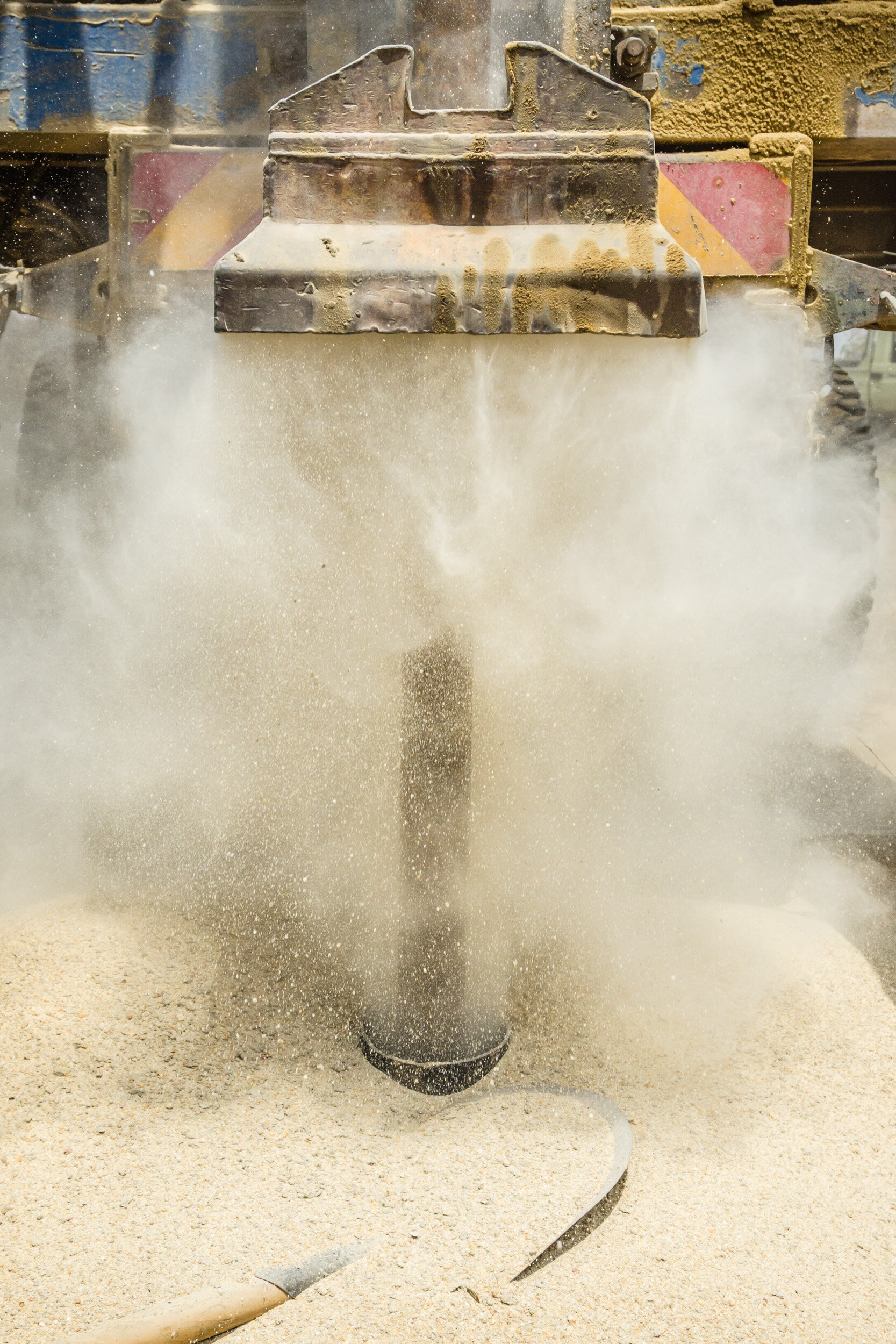 When the drill wits rock it can make quite the dust storms and toss shards of rock several feet from the drill site. (Copy)