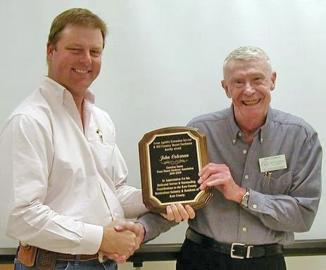 Left, AgriLife Extension Agent Roy Walston presents award to Hill Country Master Gardener co-founder John Coleman