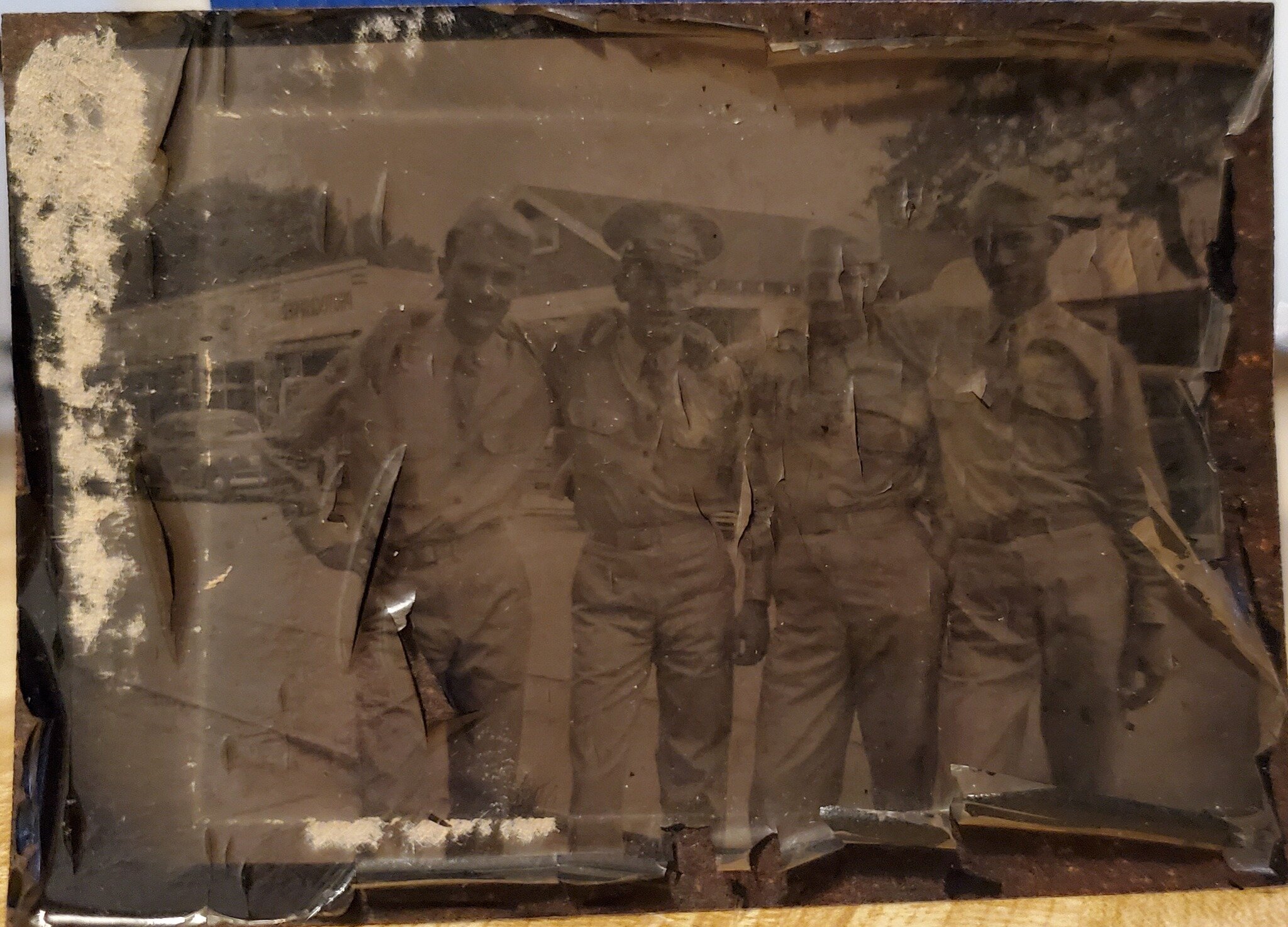 Check out this super fragile tintype photo I was hired to restore. It just came in the mail (I can't wait to get to the studio and lift their faces from the century-old fog.)
You don't know what a tintype is? You may have one. 

A tintype, also known