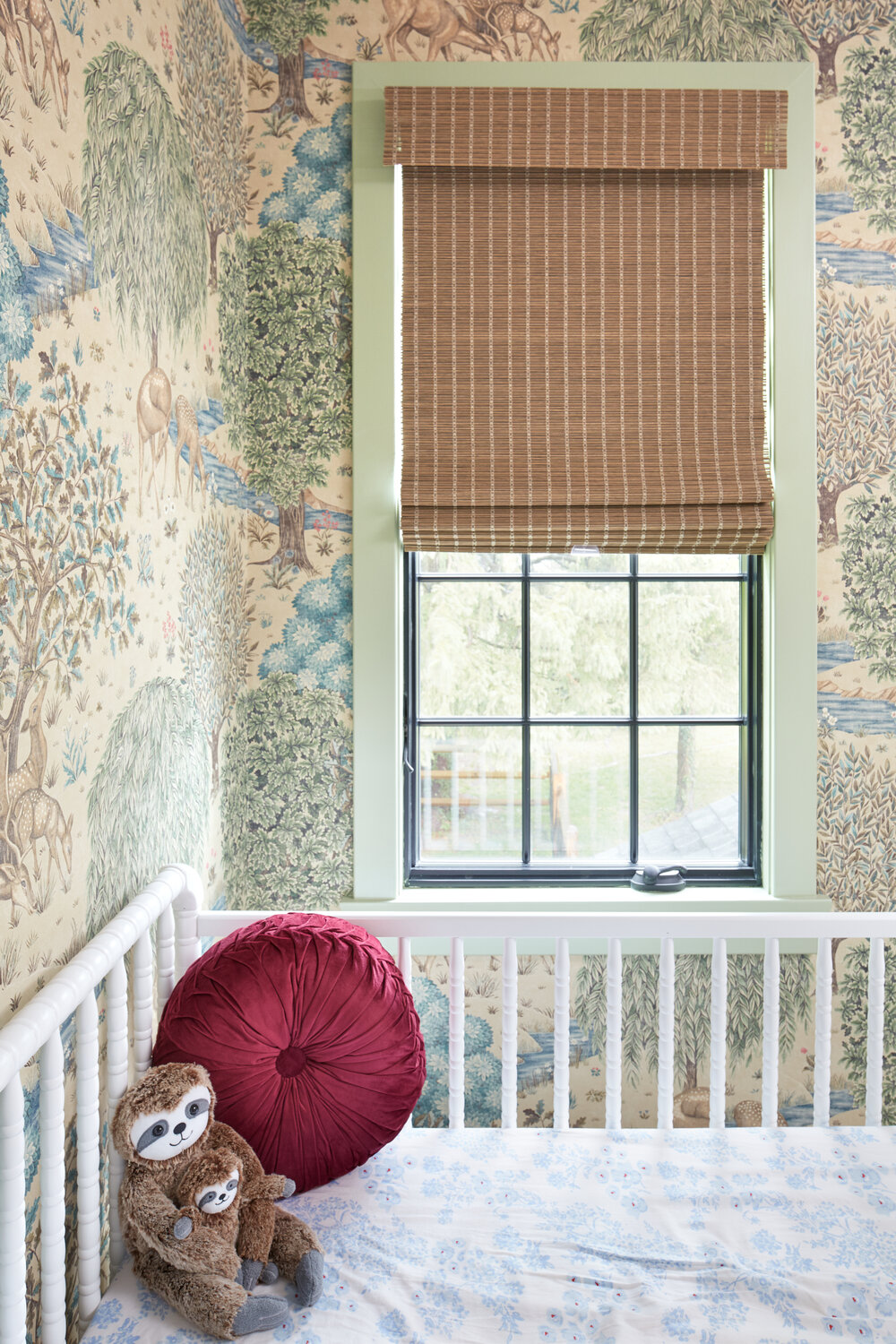 Woodland wallpaper in nursery with green painted trim by Michelle Gage.jpg