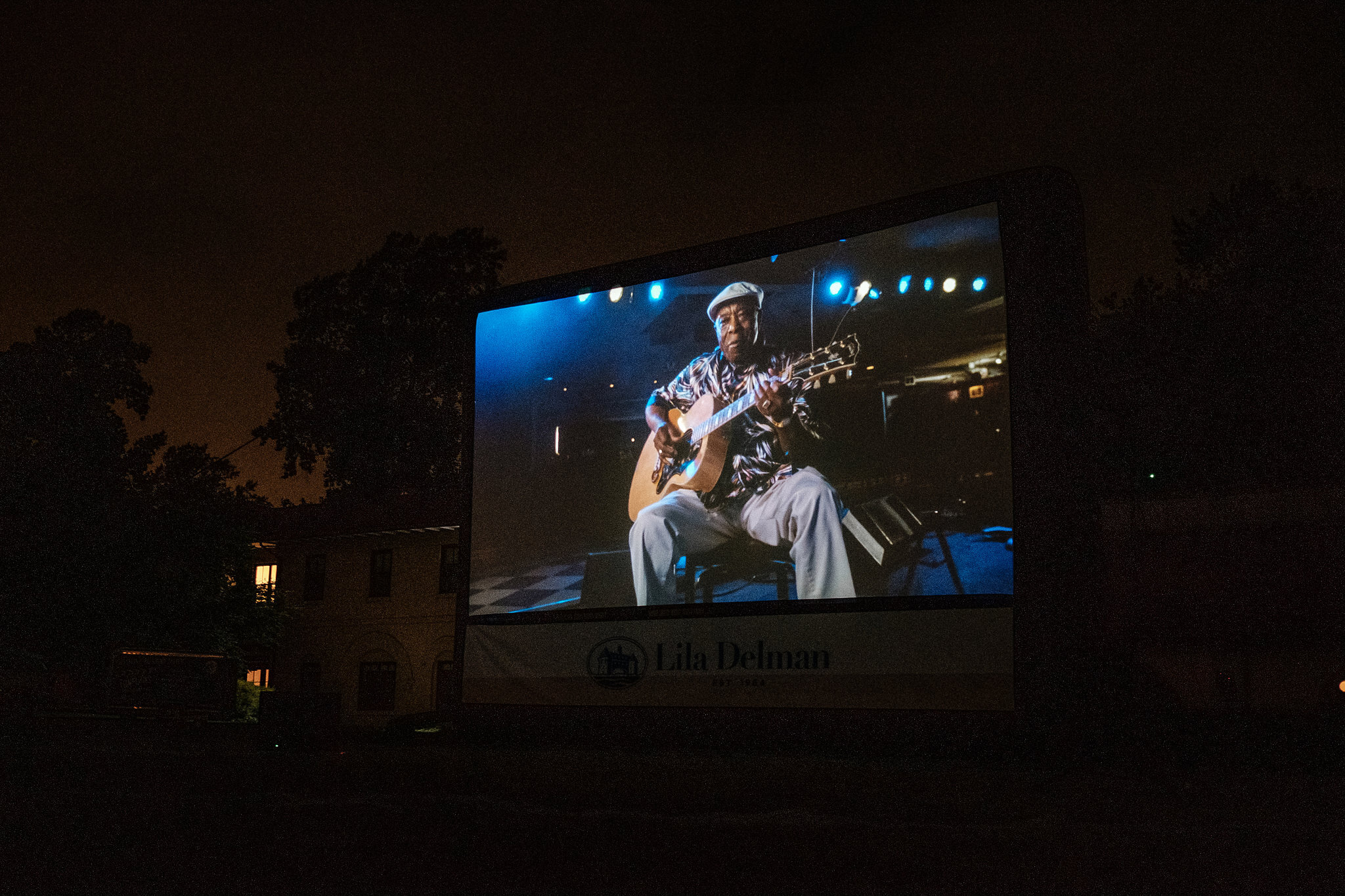  A screenshot of renowned Blues player Buddy Guy, during the outdoors screening of “Two Trains Runnin’”. 