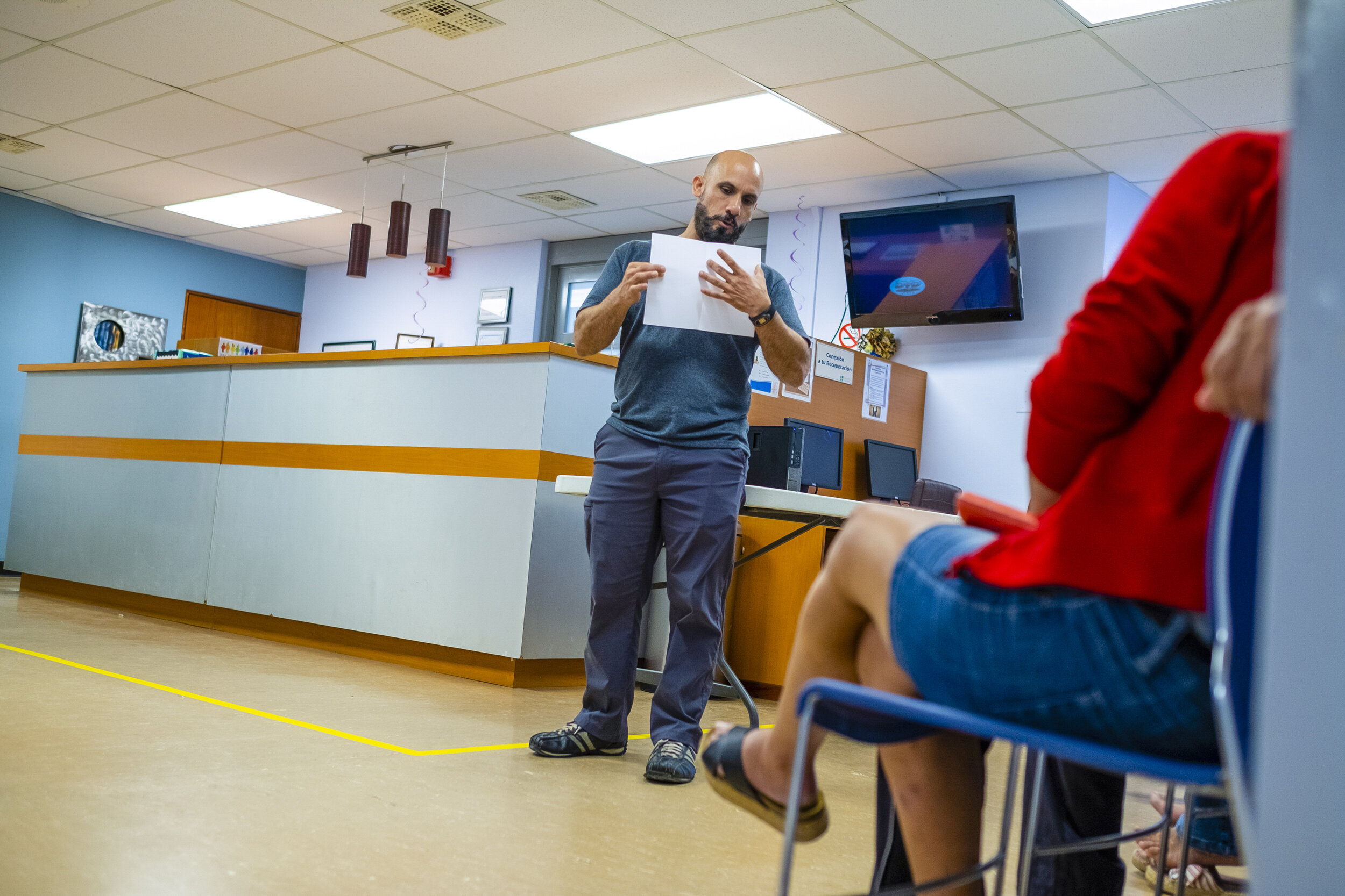  David Reyes Baerga, an occupational therapist at the PITIRRE center briefs patients on communicating with illustrations about their current state of mind on one half of a blank page, and their ideal one on the other. 