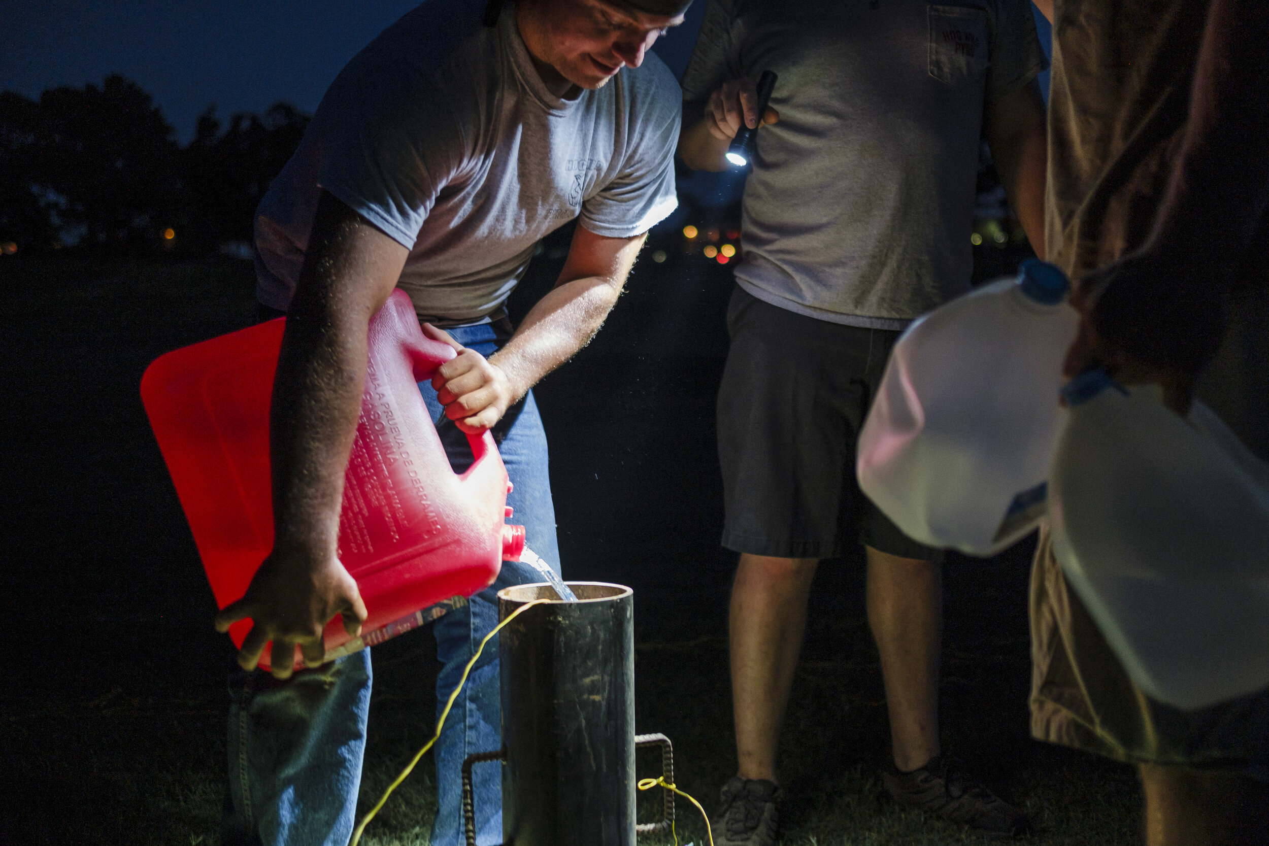  Members of the team fill a mortar with gasoline, which will produce a massive explosion for the Gran Finale.  