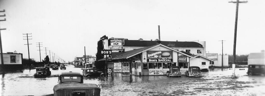 This is the only photo I have yet found of any of the hot spots out on Manchester Avenue. It was taken during the floods of 1938, looking north along Manchester about where State College comes down today. Bob’s Place (or Bob’s Barbecue) is on the corner. Besides burgers, malts, and chicken pies, it was sometimes busted for serving alcohol to minors.