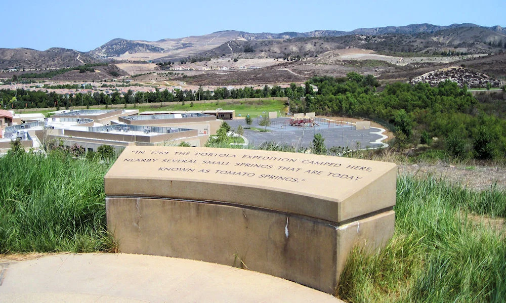 This historical marker stands above Portolá Springs Elementary School in Irvine. Tomato Springs was located in the low hills to the right. The expedition camped a short ways west of this little hill.