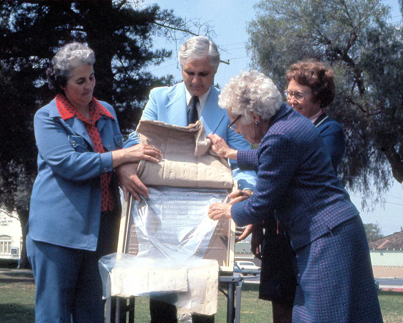 Florence Smiley, who attended classes on this site in the 1890s, unveils the plaque, March 26, 1976. Assisting are Orange Unified School District Trustee Ruth Evans, OUSD Superintendent Donald Ingwerson, and Maxine Schenck of the Association of California School Administrators. (Photo by Phil Brigandi)
