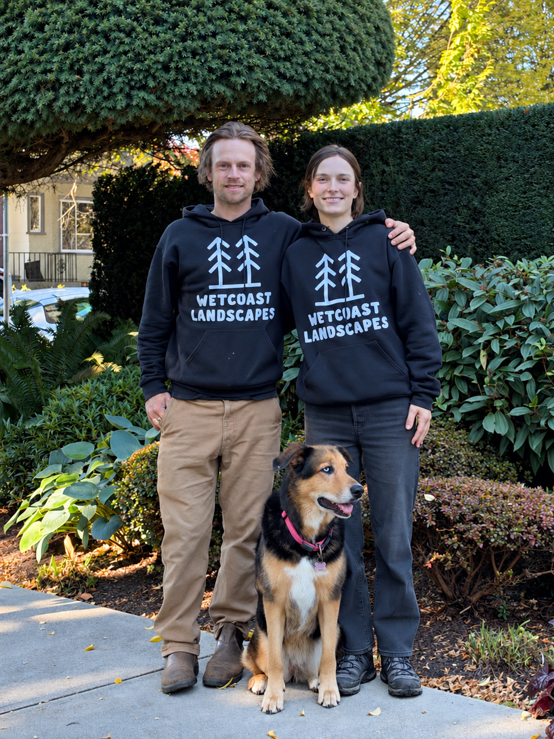 Tim Colwell and Taryn Kelpin of Wetcoast Landscapes with their dog Florence in a garden