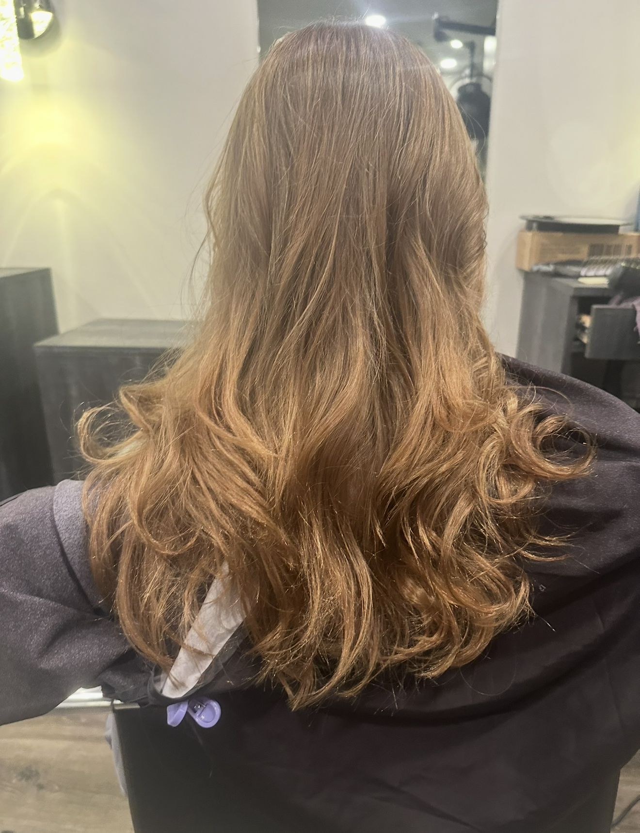 Bronde hair color with soft blowout waves at Clarendon Hills hair salon