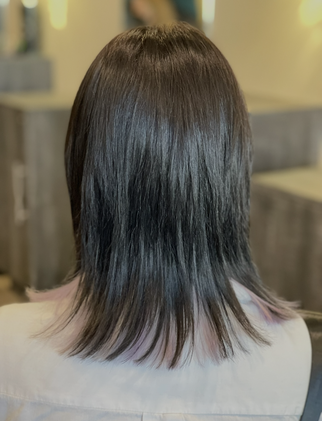 Brunette lob haircut with hidden pastel peekaboo color