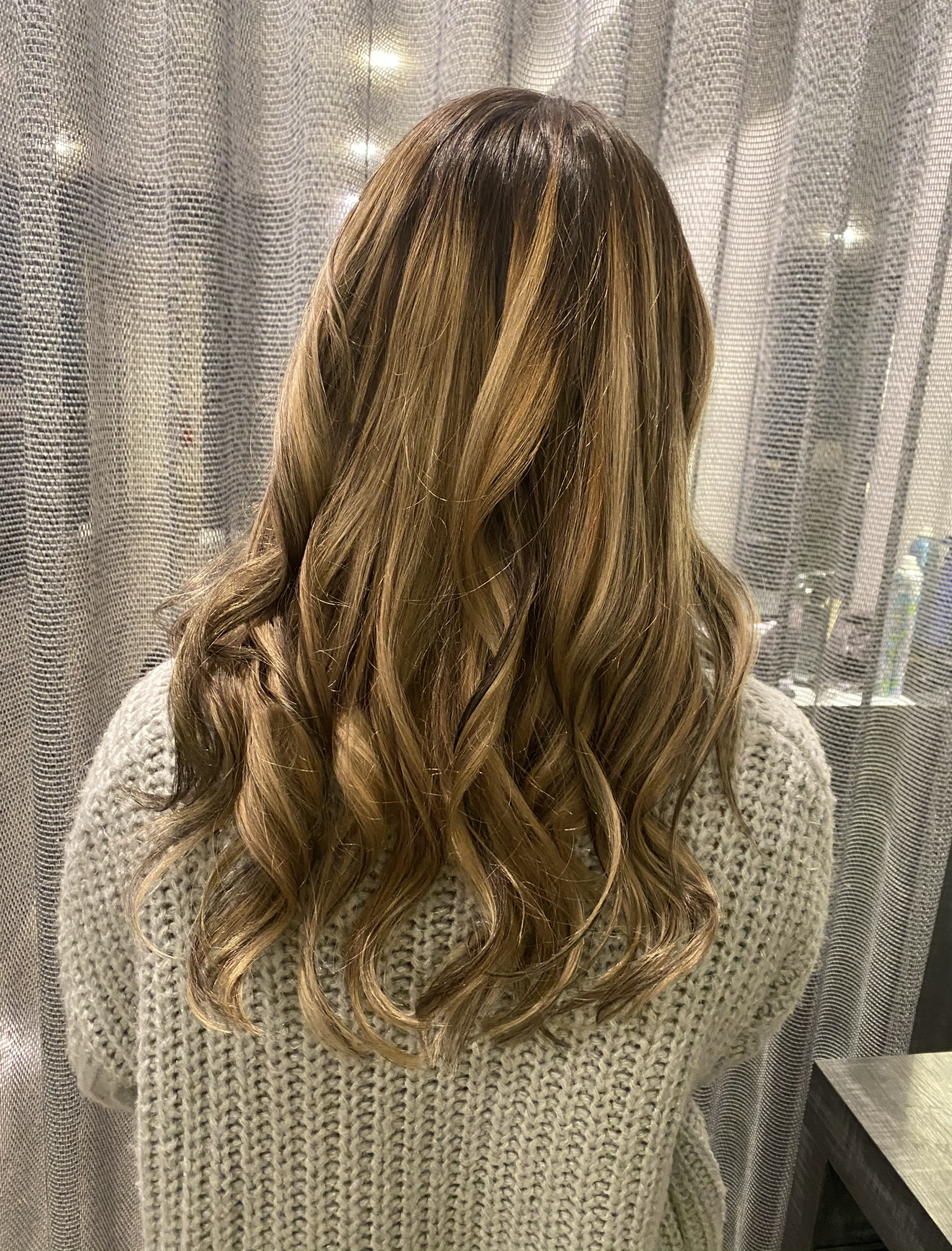 Warm caramel balayage on brunette hair at Salon Sapphire