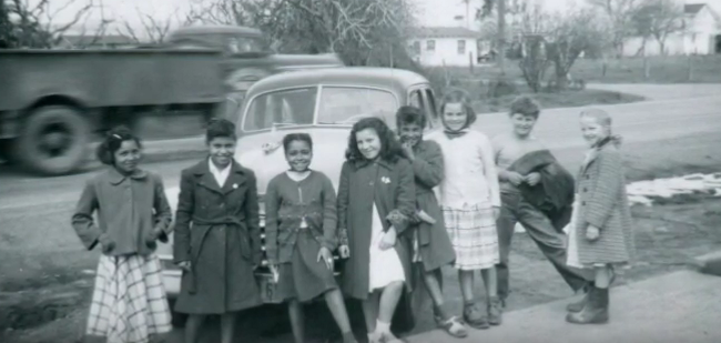 RC girls leaning on car.png