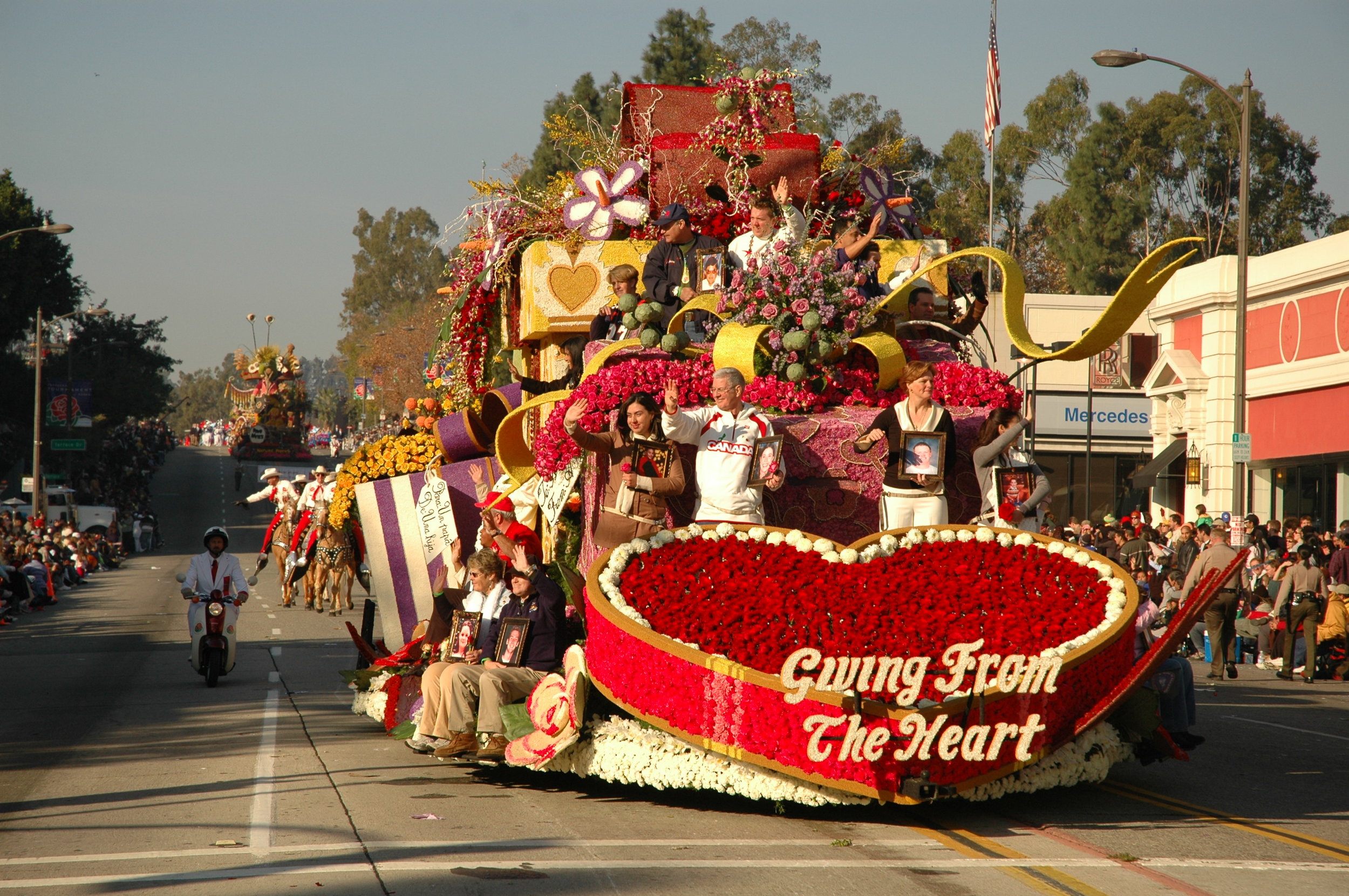A number of white tags, approved as a non-organic variance by the Tournament of Roses, peaked through the blooms to reveal the meaningful messages attached to the vials in the iconic red heart. (Photo: Scott Weersing)