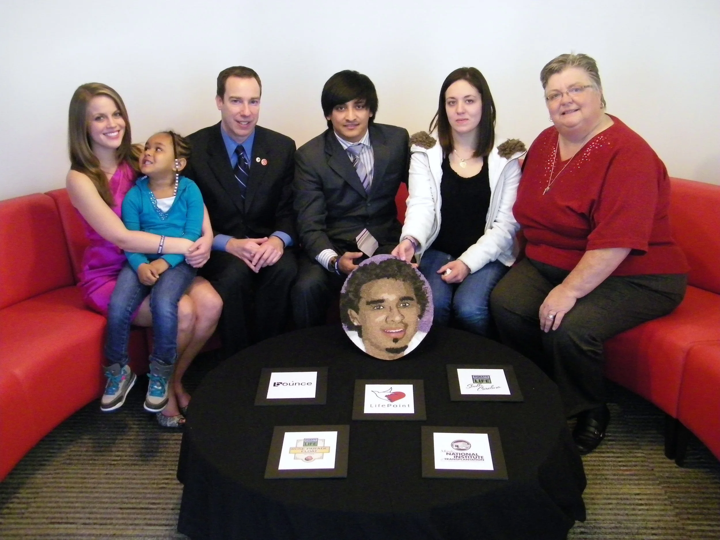 Mark Johnson (third from left) of South Carolina's organ recovery agency joined family members of floragraph honoree Darwin Javier Rivera to complete his portrait. (Photo: Sharing Hope SC)