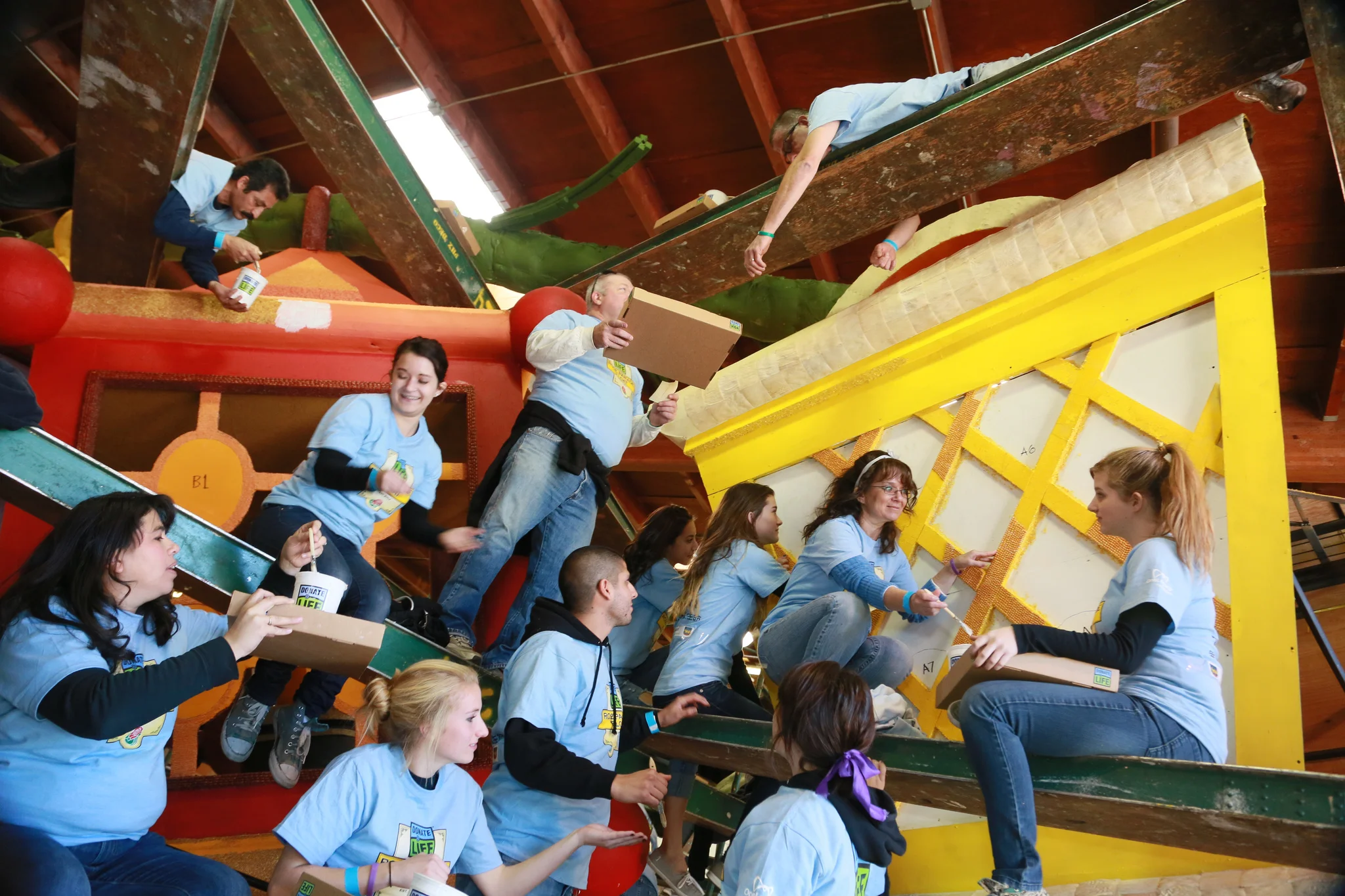 A swarm of blue shirts contributed to decorating the ornate, textured lanterns. (Photo: Chris Chavira)
