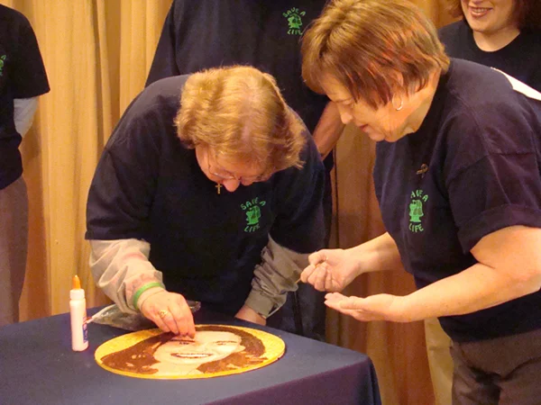 Donate Life's first floragraph finishing event in Colorado enabled Melody Connett and Carol Pirri to decorate the portrait of Jill Connett, their daughter and liver donor, respectively.