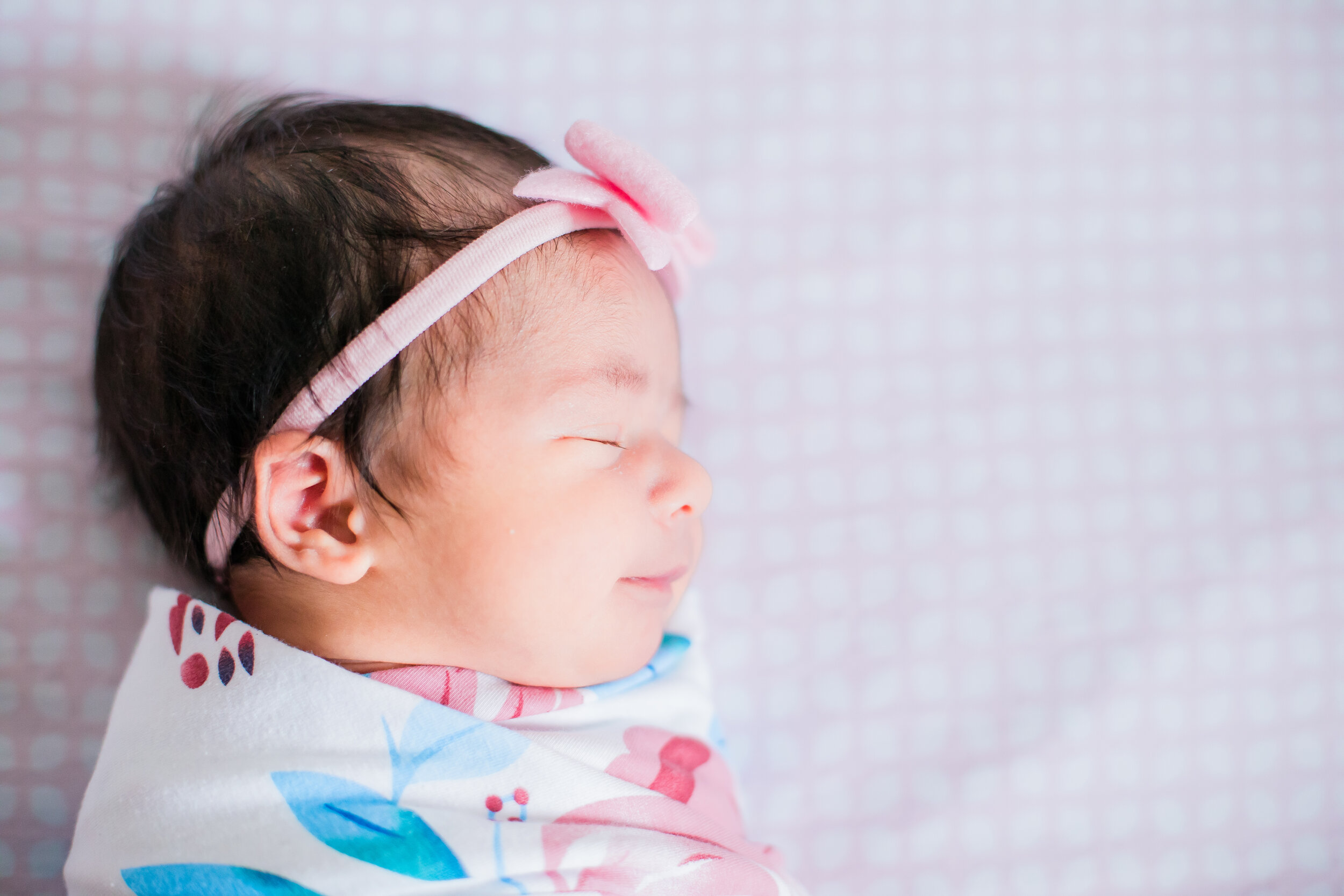Fresno newborn photograph, baby girl smiling in her sleep