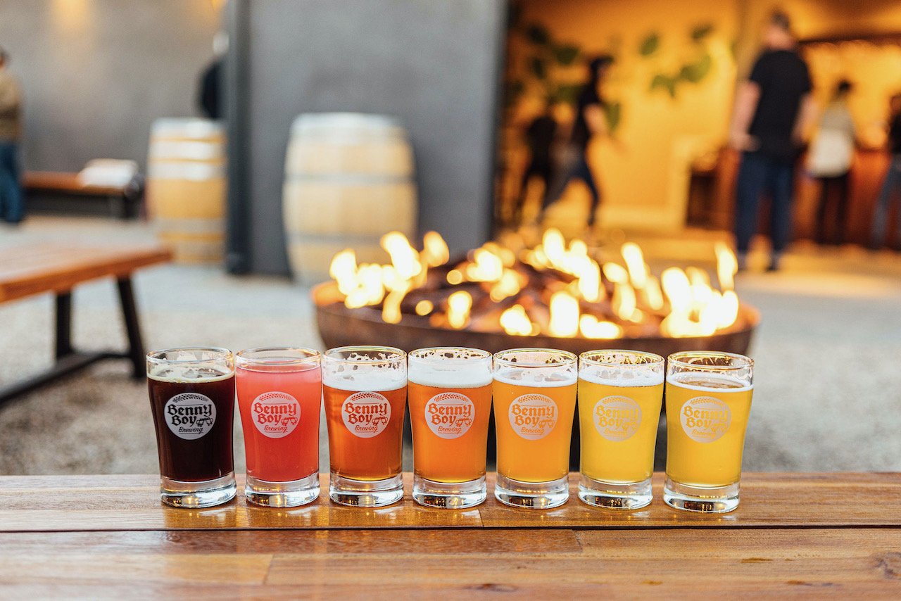 A line up of tasters in a flight in front of the fire pit