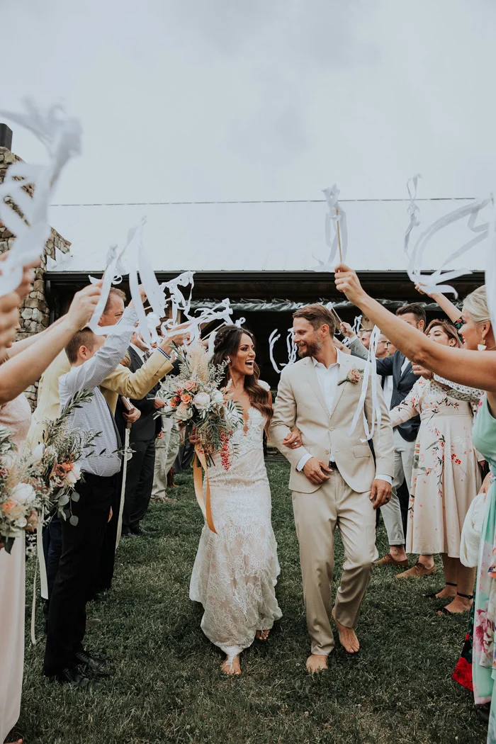 wedding party cheering for the bride and groom at their wedding in the blue ridge mountains at cabin ridge in asheville, north carolina