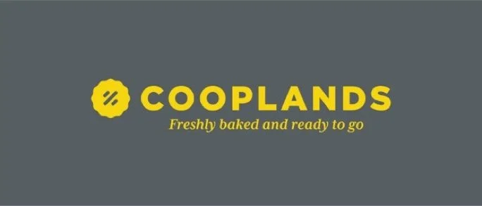 Cooplands logo with yellow text and slogan on gray background
