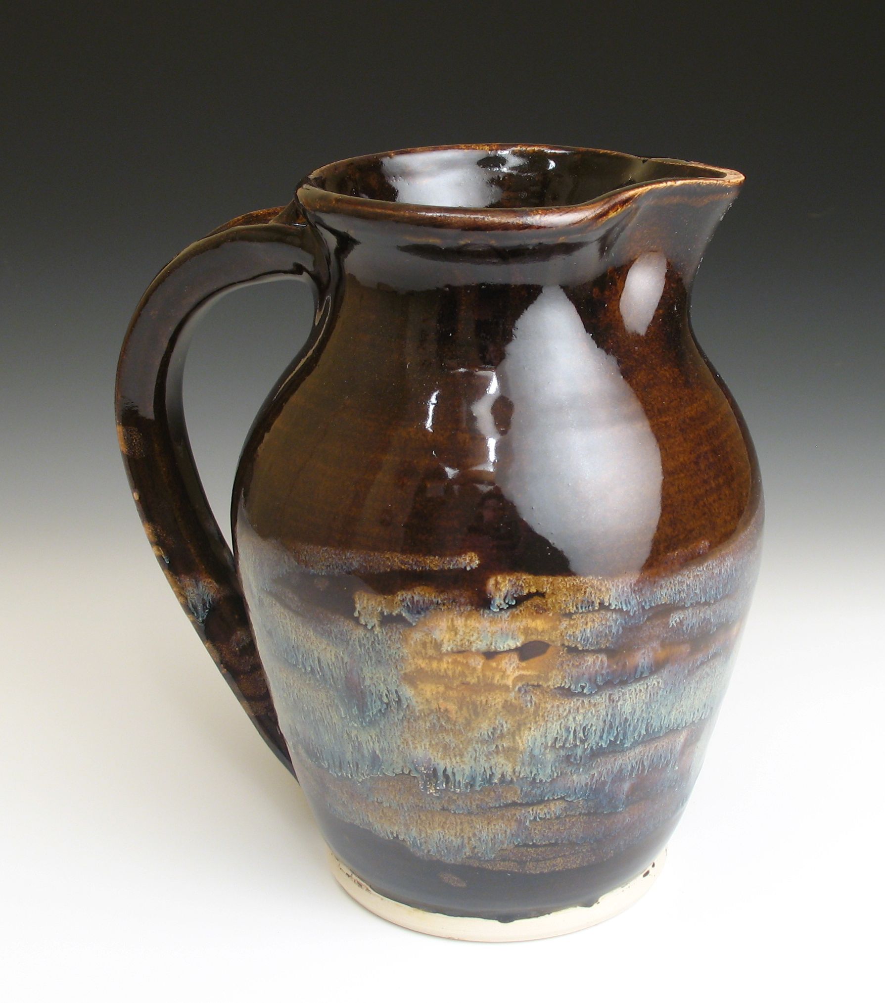 Tenmoku glaze with earthtone drips fired to cone 6 oxidation