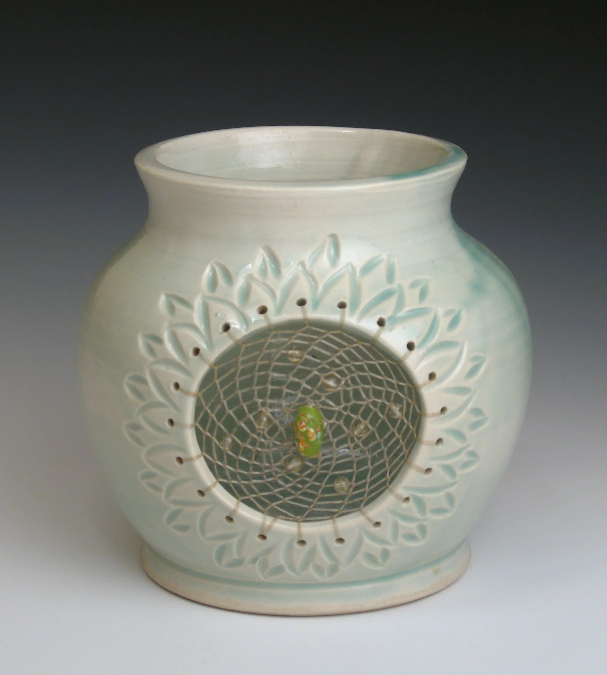 Porcelain Dreampot with celedon glaze and peridot beads fired to cone 6 oxidation