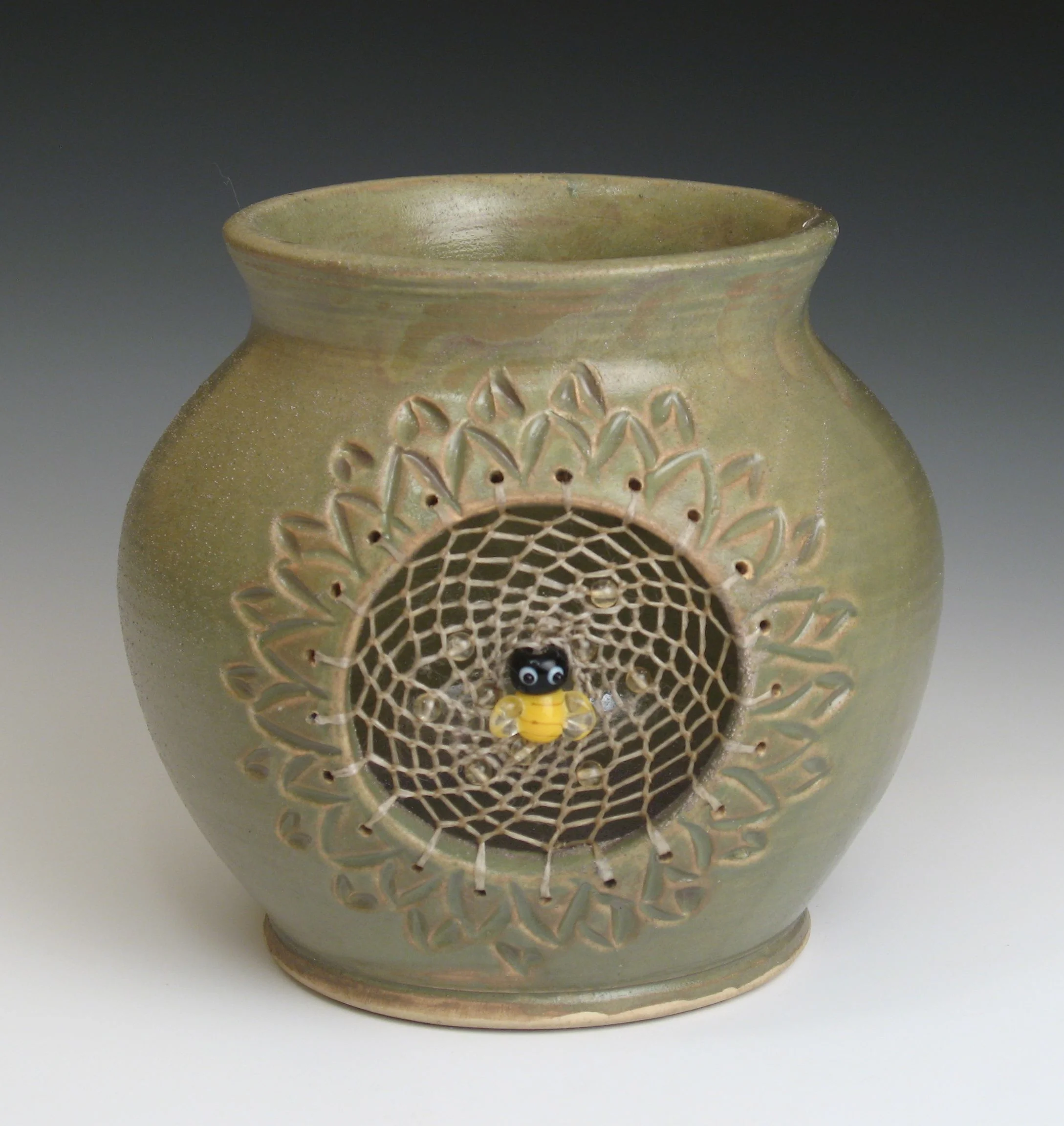 Dreampot with green glaze, glass bee bead and peridot beads fired to cone 6 oxidation