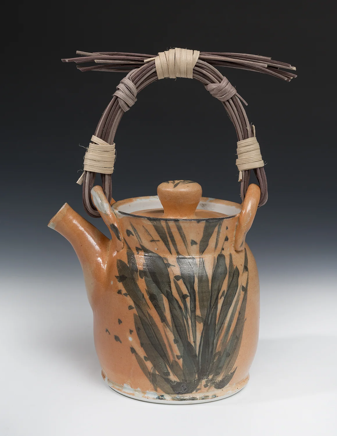 High-fired reduction shino teapot with hand-woven reed handle