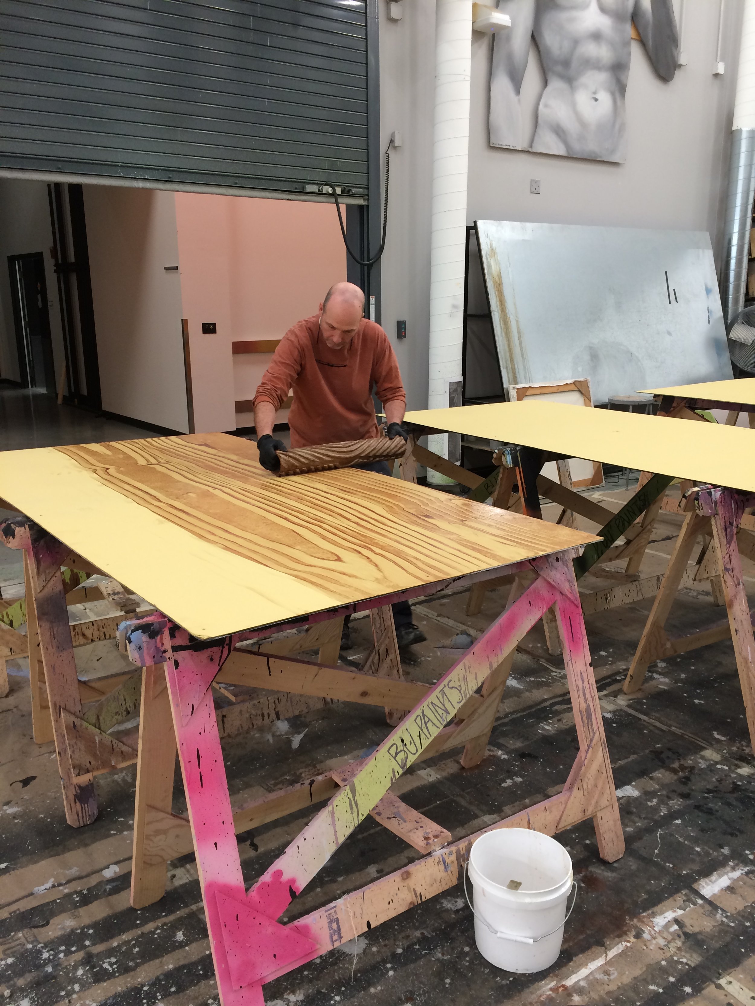  Assistant Charge Timothy Lewis graining a sheet of the floor 