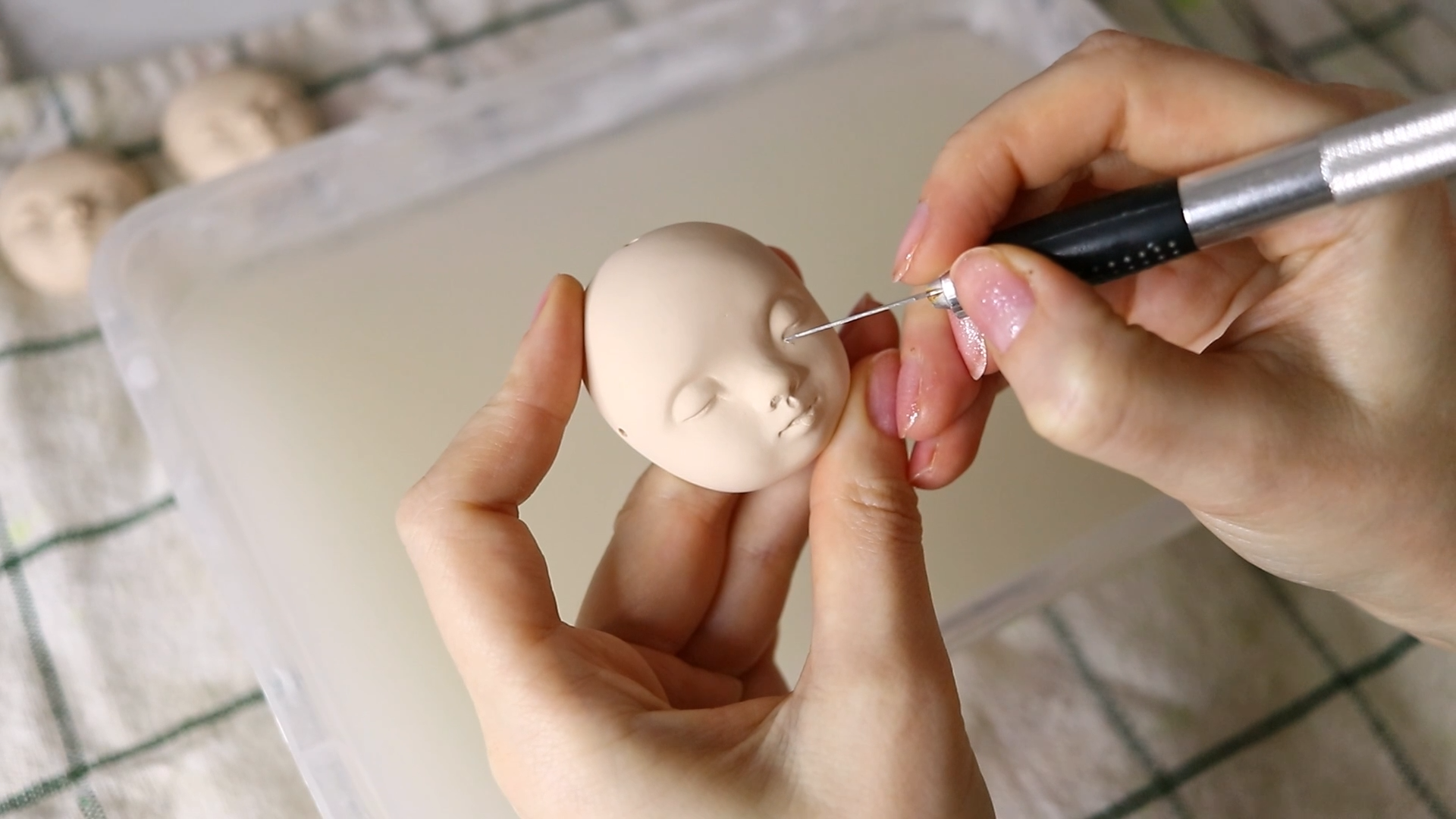 Carving bisque-fired porcelain faces