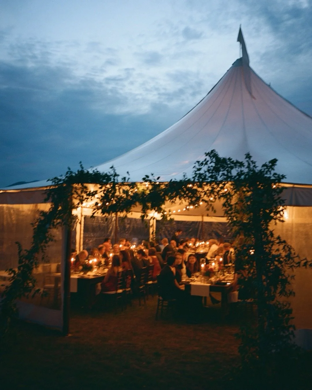 Moments and details on film from Katya and Jeremy&rsquo;s wedding at the gorgeous @hillfarmvermont with florals by @tipsytulipdesigns. There is something so cozy about a tent lit up on a fall evening right as the sun sets behind the mountains.