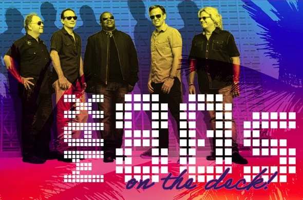 Five men stand together in front of a colorful, stylized background with the text “80s on the dock!” written across the image.