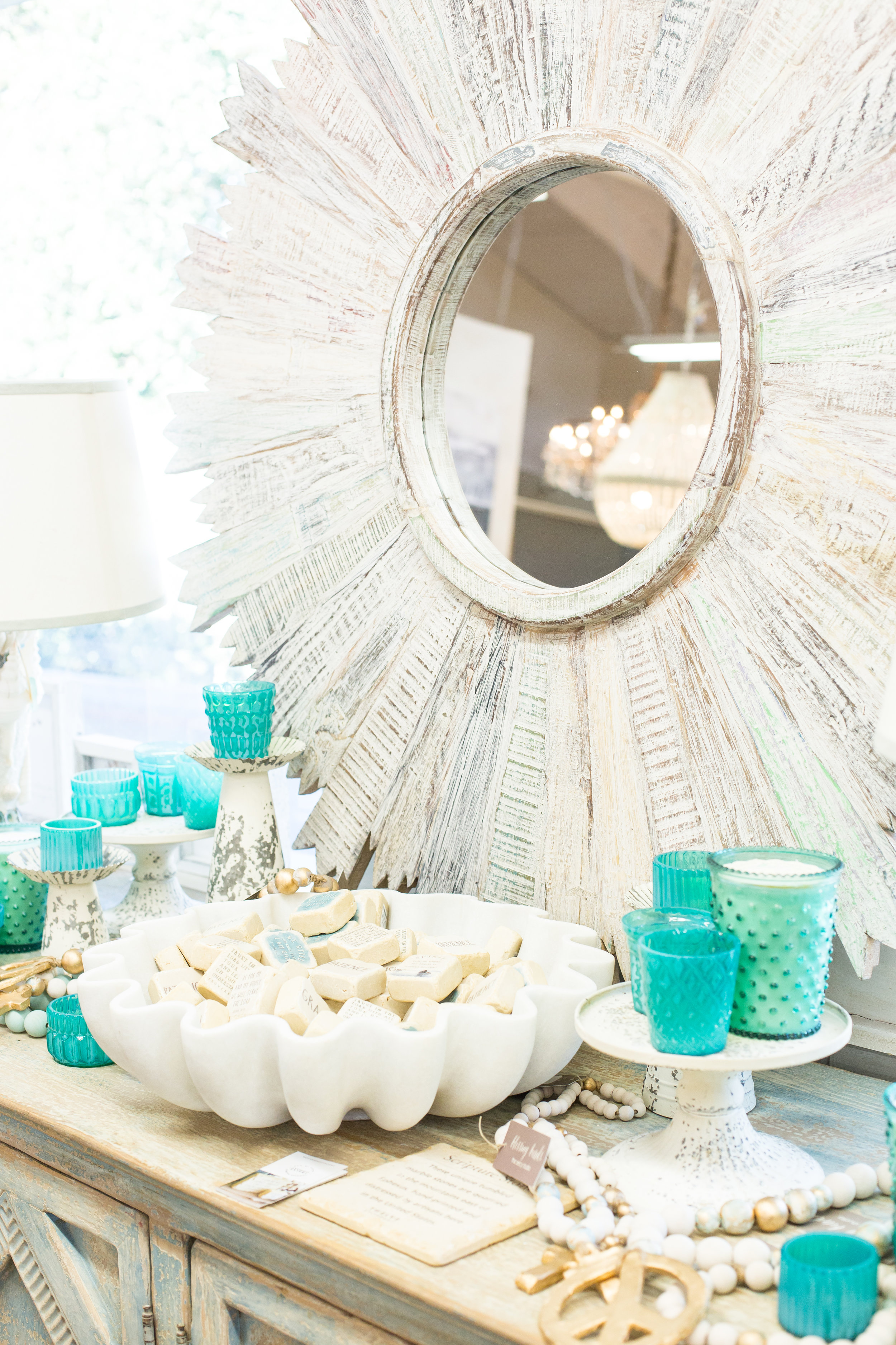 White sunburst mirror, candles, decor