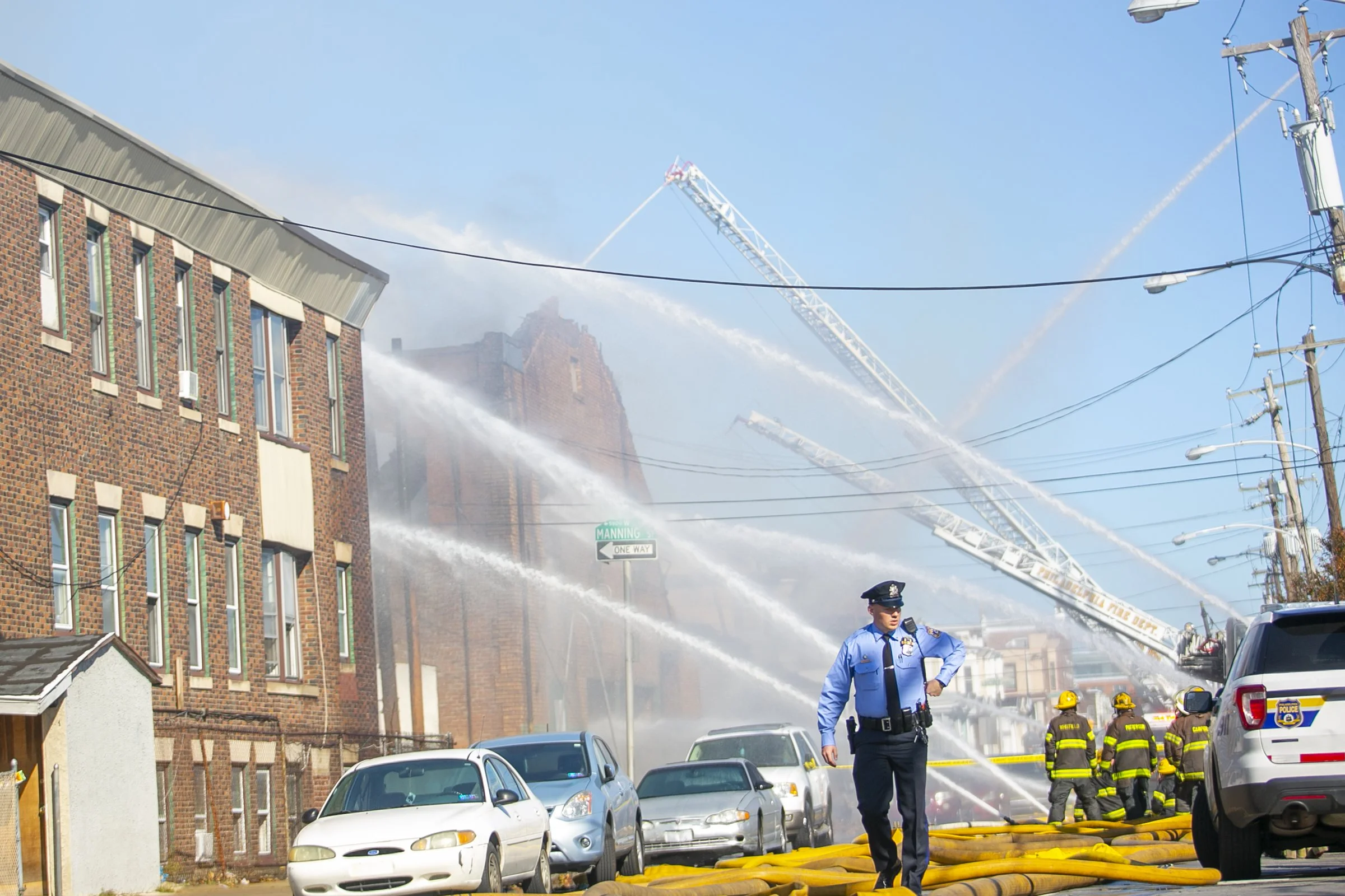  A police office walks away from a fire scene in West Philadelphia.  