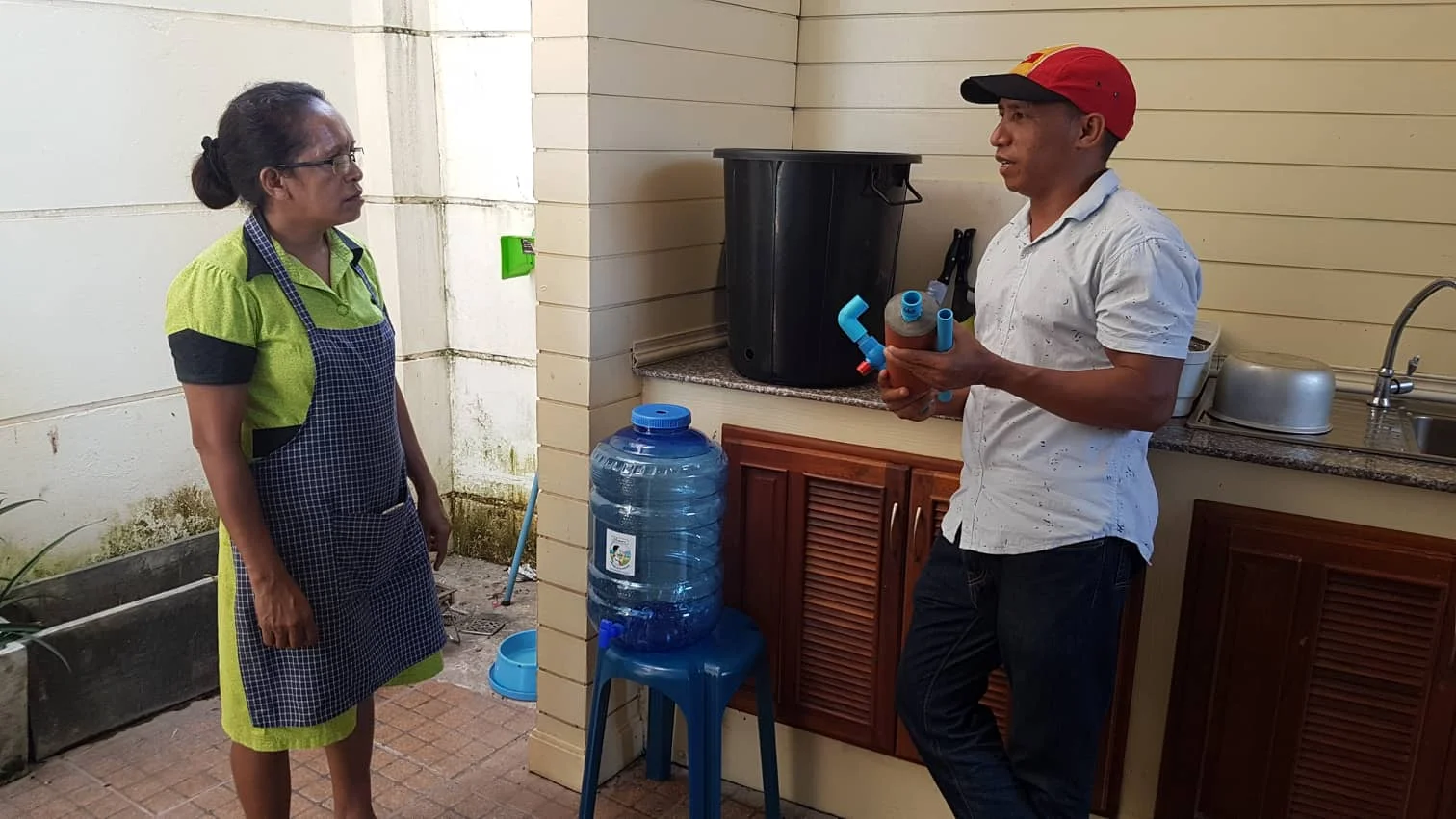 Image 2: Abundant Water’s Timorese trainee Joanico Da Silva installing an Abundant Water at the residence of the Ambassador of the Timor-Leste Embassy in Vientiane, Natália Carrascalão.