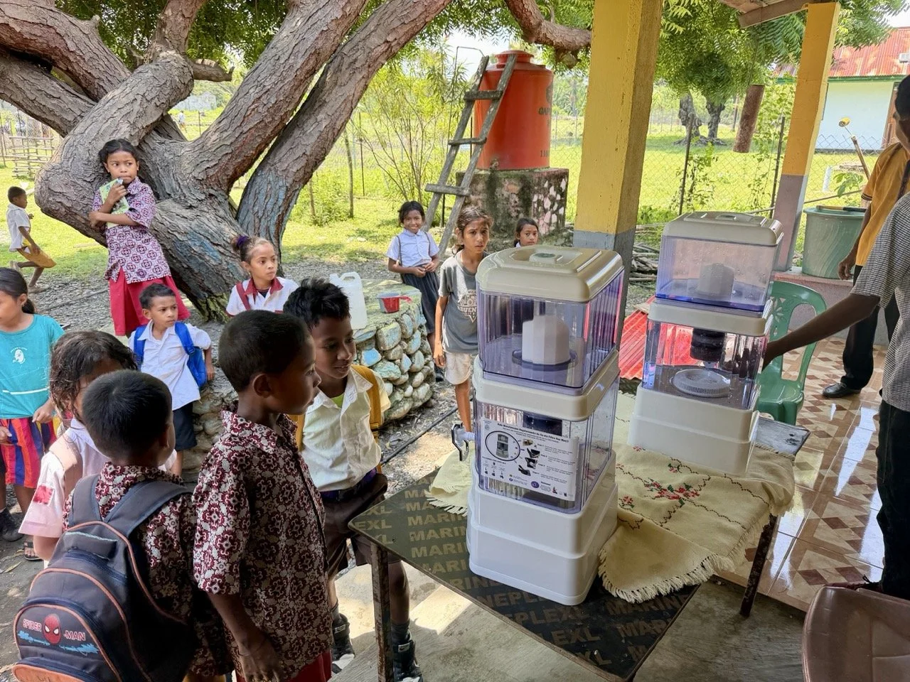 Curious students examine their school's new water filters at Guiço Primary School in Guiço village, Timor-Leste.