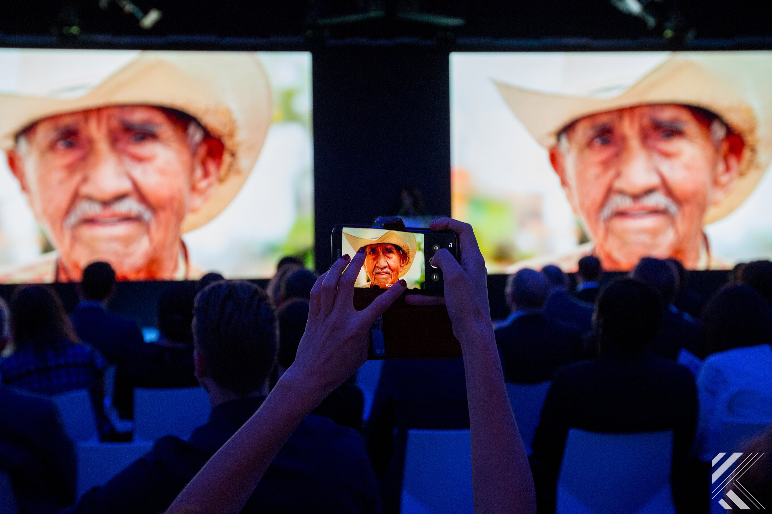 Attendee taking picture of screen during conference