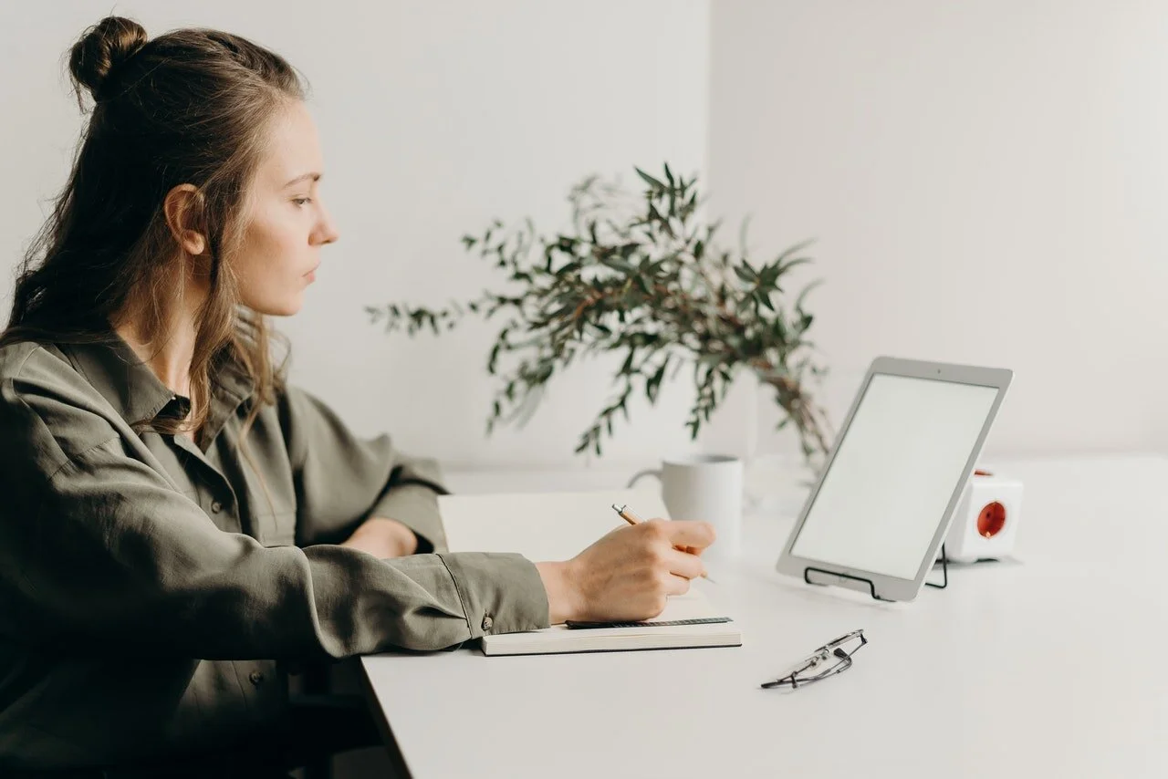 woman-in-gray-coat-using-white-laptop-computer-4065891.jpg