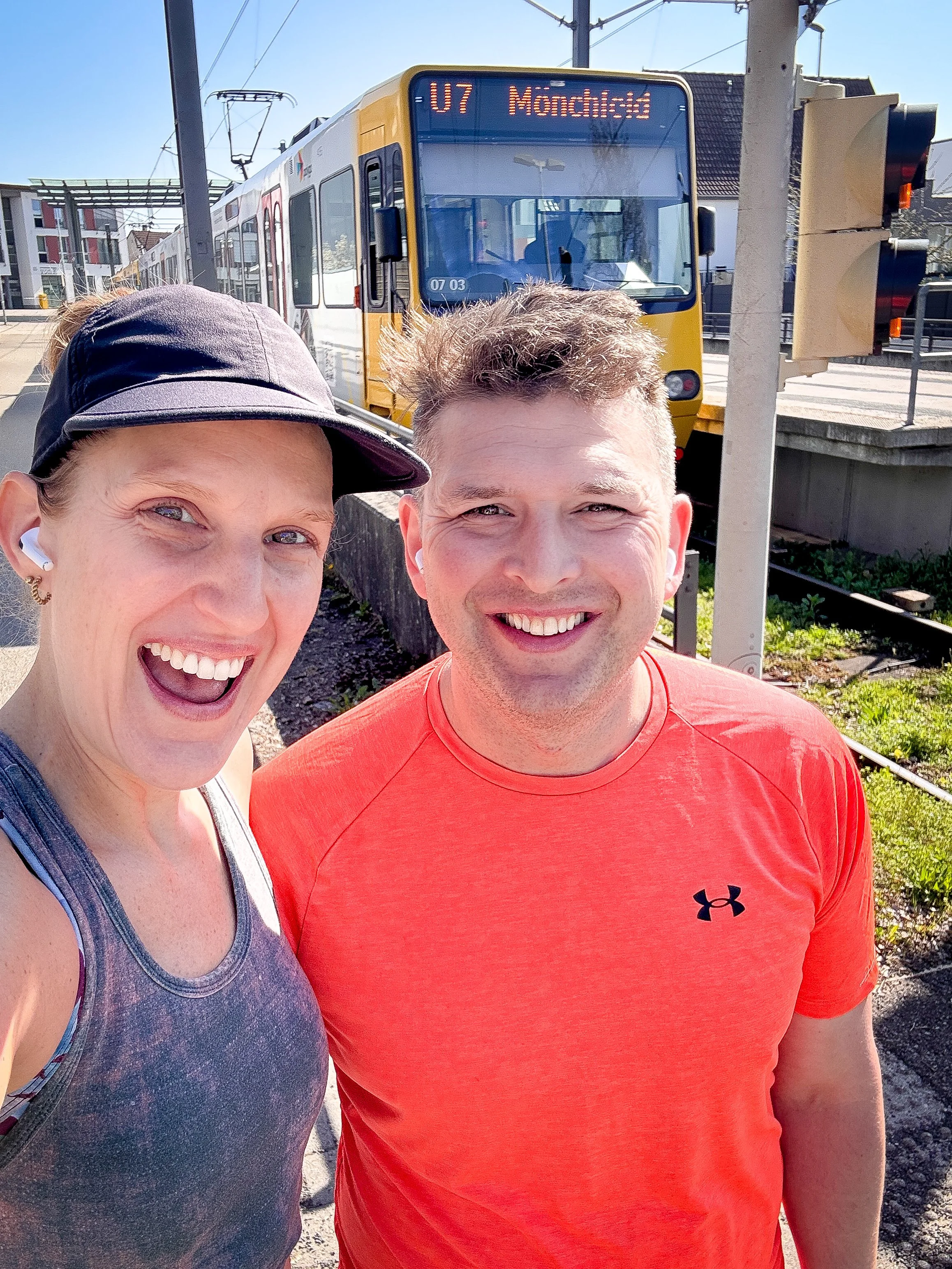 Smiling runners standing in front of a Stuttgart U-Bahn train during a running challenge, representing one of the biggest wins from the 2025 goals list.