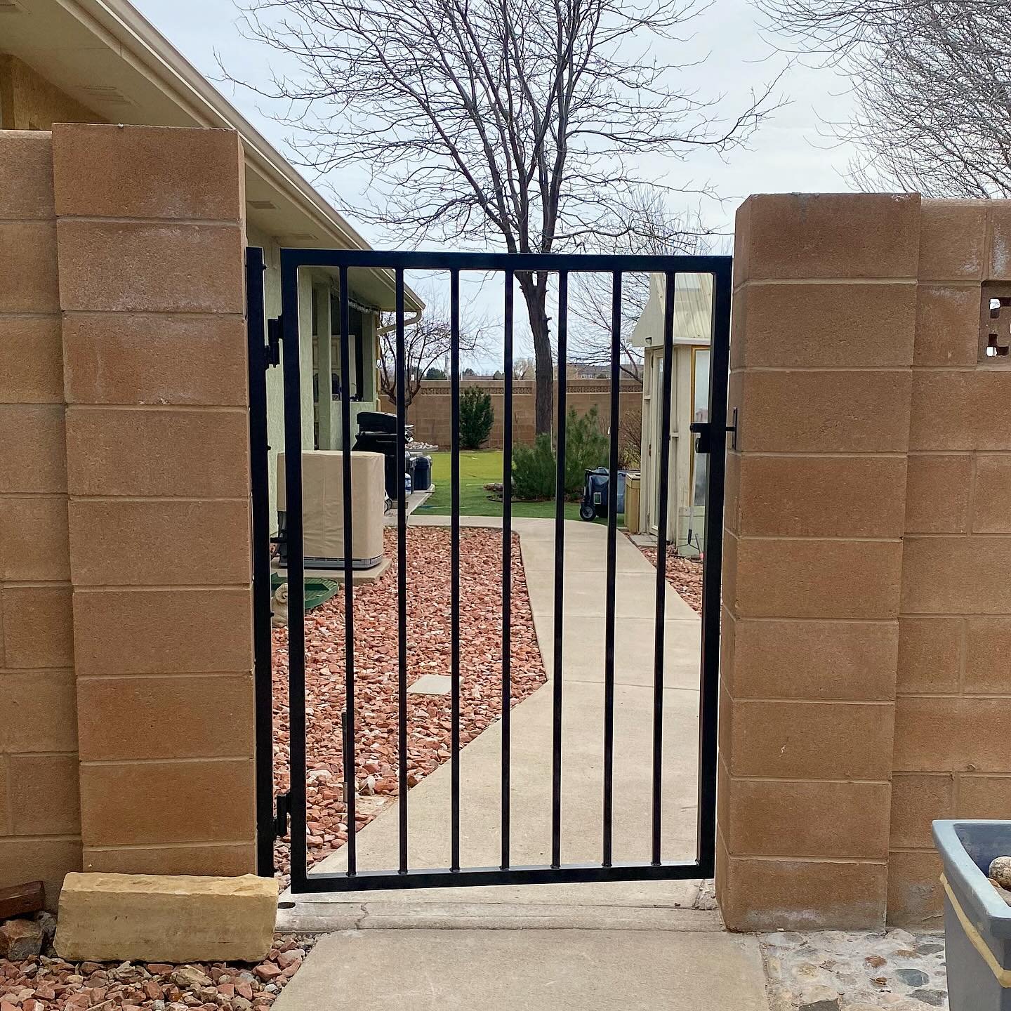 Simple and functional.

This gate swings smoothly both ways making it easy to get in and out with trash bins and wheelbarrows. The plain pickets provide a clear view out while preventing larger animals and unwanted people from getting in.

We make ga