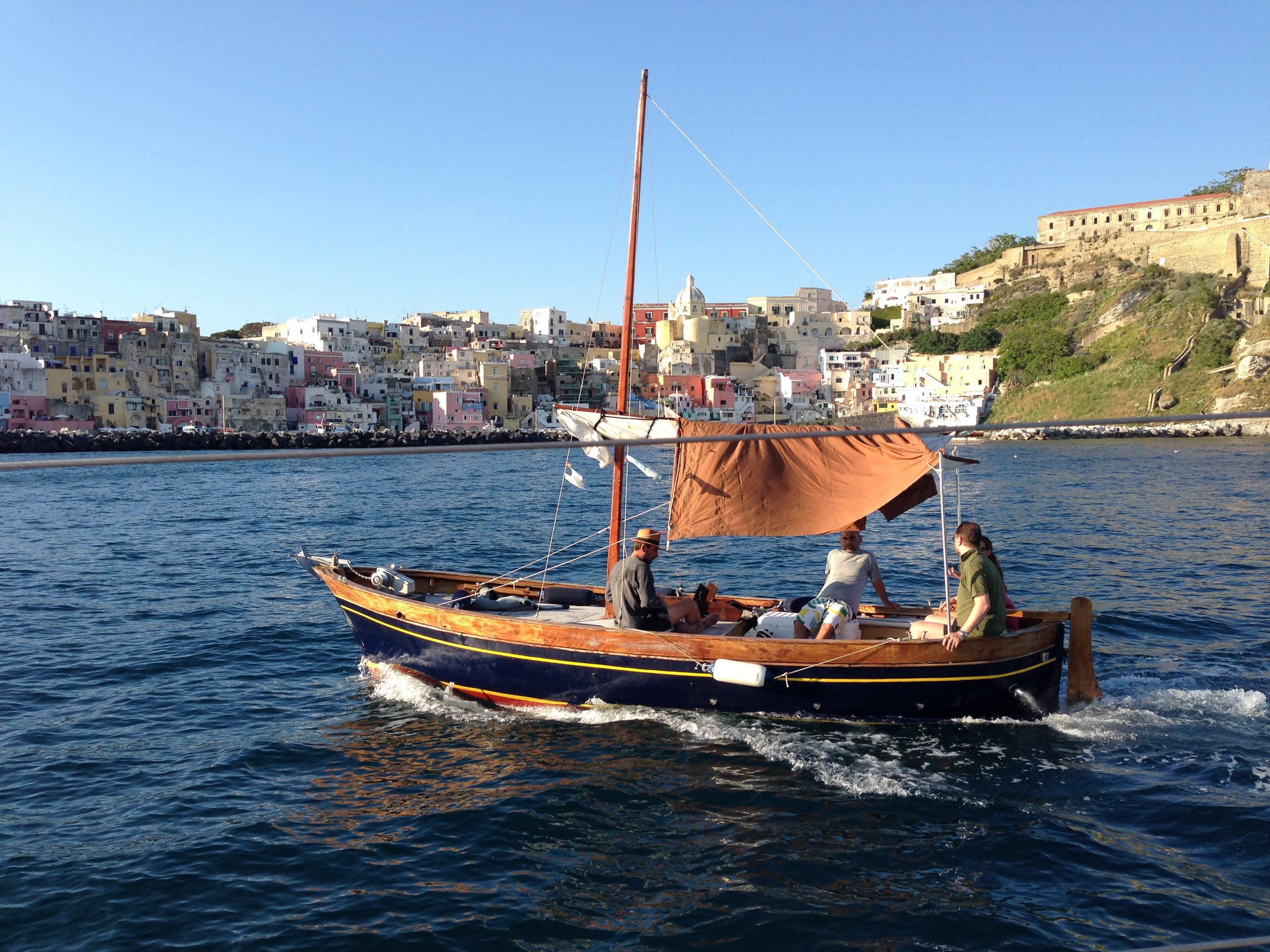 Typical "gozzo" boat with Corricella in the background