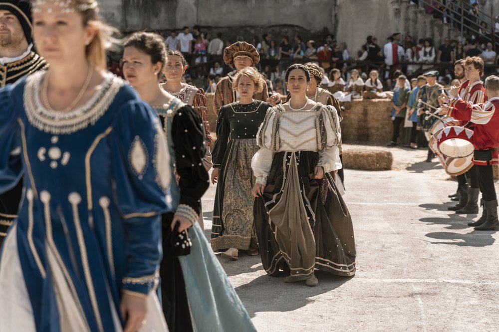   The drummer beats in the background during the procession of the Nobles as they walk towards their seats to watch the final competition of the weekend: “la rara et bella cursa all’anello”  