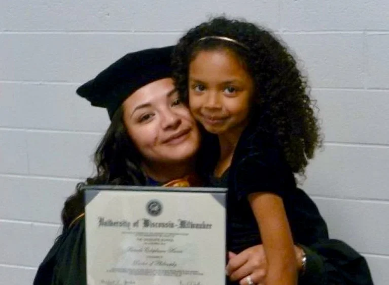 Dr. Pamela E. Harris with her daughter Akira during her PhD graduation.