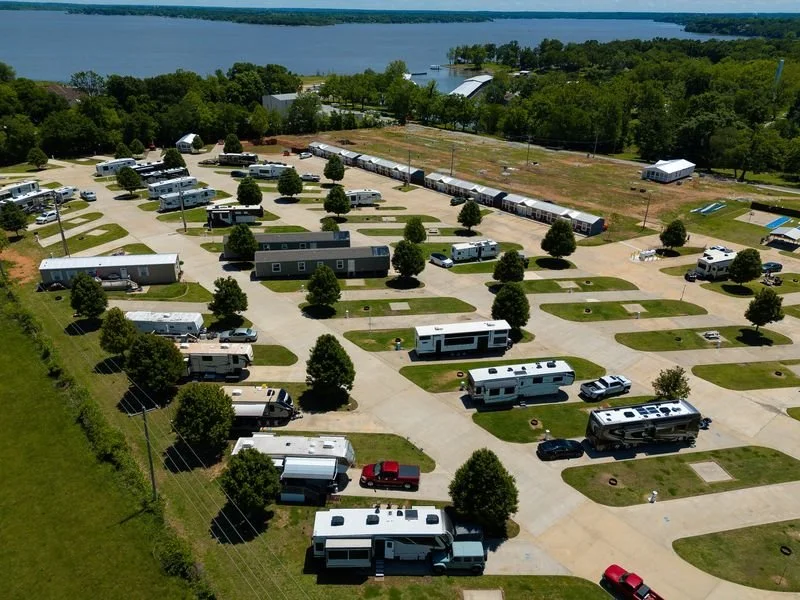 Aerial view of Monkey Island Resort near Grand Lake, Oklahoma featuring spacious RV sites, resort homes, landscaped grounds, and nearby lake access.